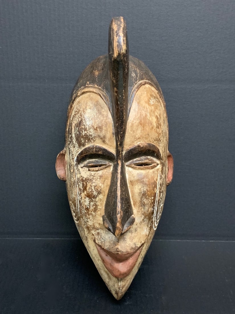 Ibo Mask: African Tribal Art Carved Wood Ibo Mask. The dimension is 16 inches high x 8 inches wide. Please be aware that some of the items are vintage, secondhand, old ages, antiques and may have a defects or