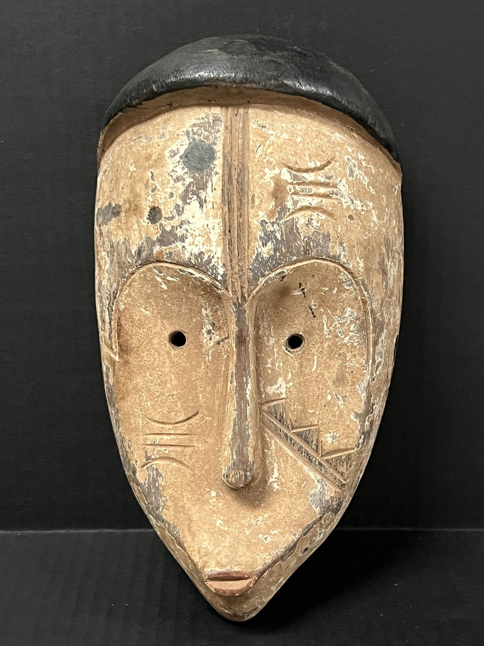 Fang Mask: African Tribal Art Carved Wood Fang Mask. The dimension is 8 inches high x 5 inches wide. Please be aware that some of the items are vintage, secondhand, old ages, antiques and may have a defects or