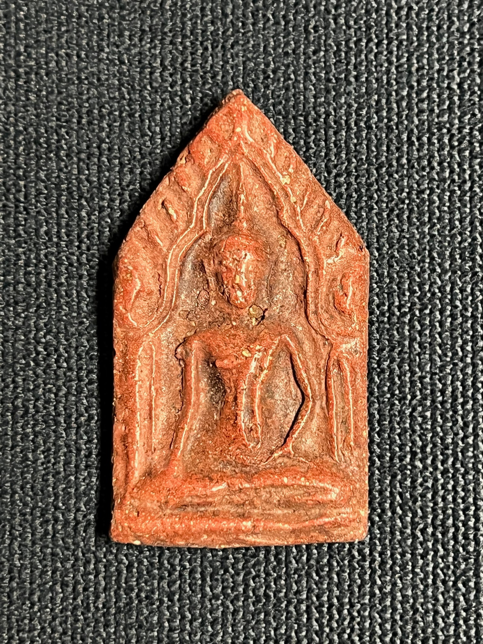Southeast Asian Clay Buddha Amulet: Southeast Asian Clay Buddha Amulet. The dimension is 1.5 inches high x 1 inches wide. Please be aware that some of the items are vintage, secondhand, old ages, antiques and may have a defects or sign