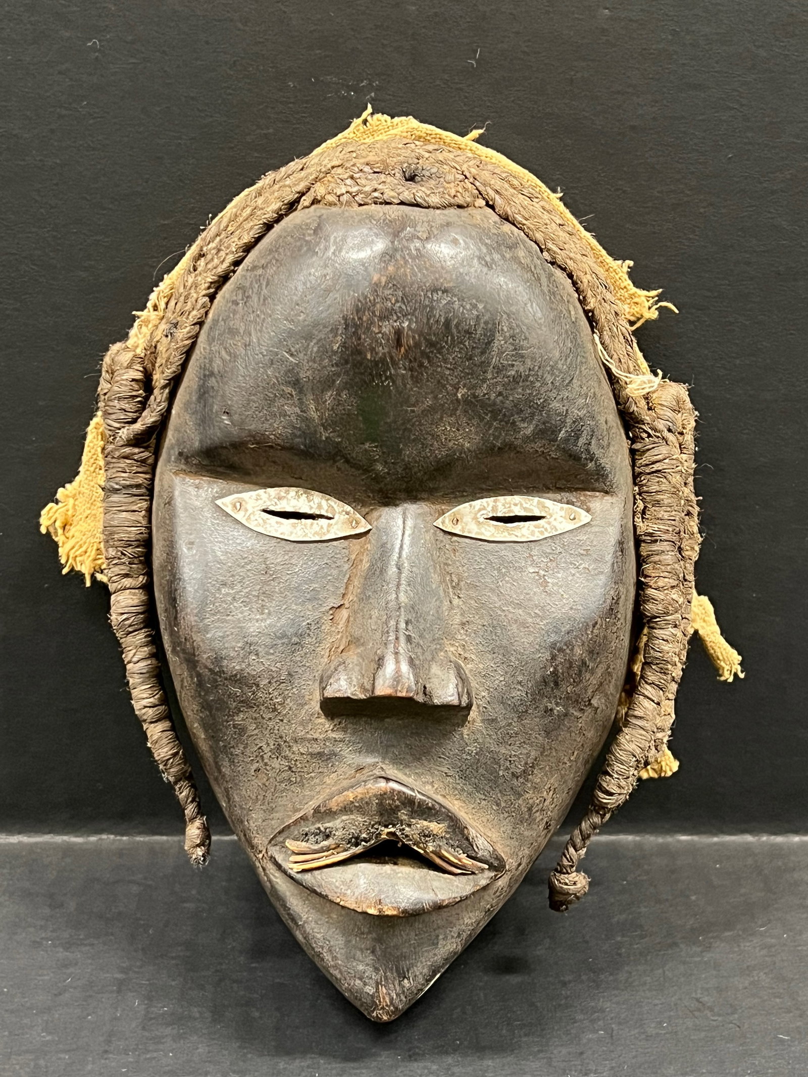 Carved Wood Dan Mask: African Tribal Art Carved Wood Dan Mask. The dimension is 8.5 inches high x 6 inches wide. Please be aware that some of the items are vintage, secondhand, old ages, antiques and may have a defects or