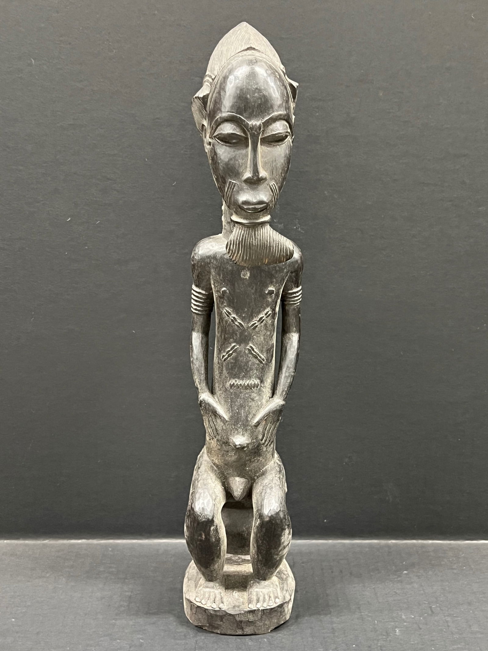 Carved Wood Baule Statue: African Tribal Art Carved Wood Baule Statue. The dimension is 17.5 inches high x 4 inches wide. Please be aware that some of the items are vintage, secondhand, old ages, antiques and may have a defect