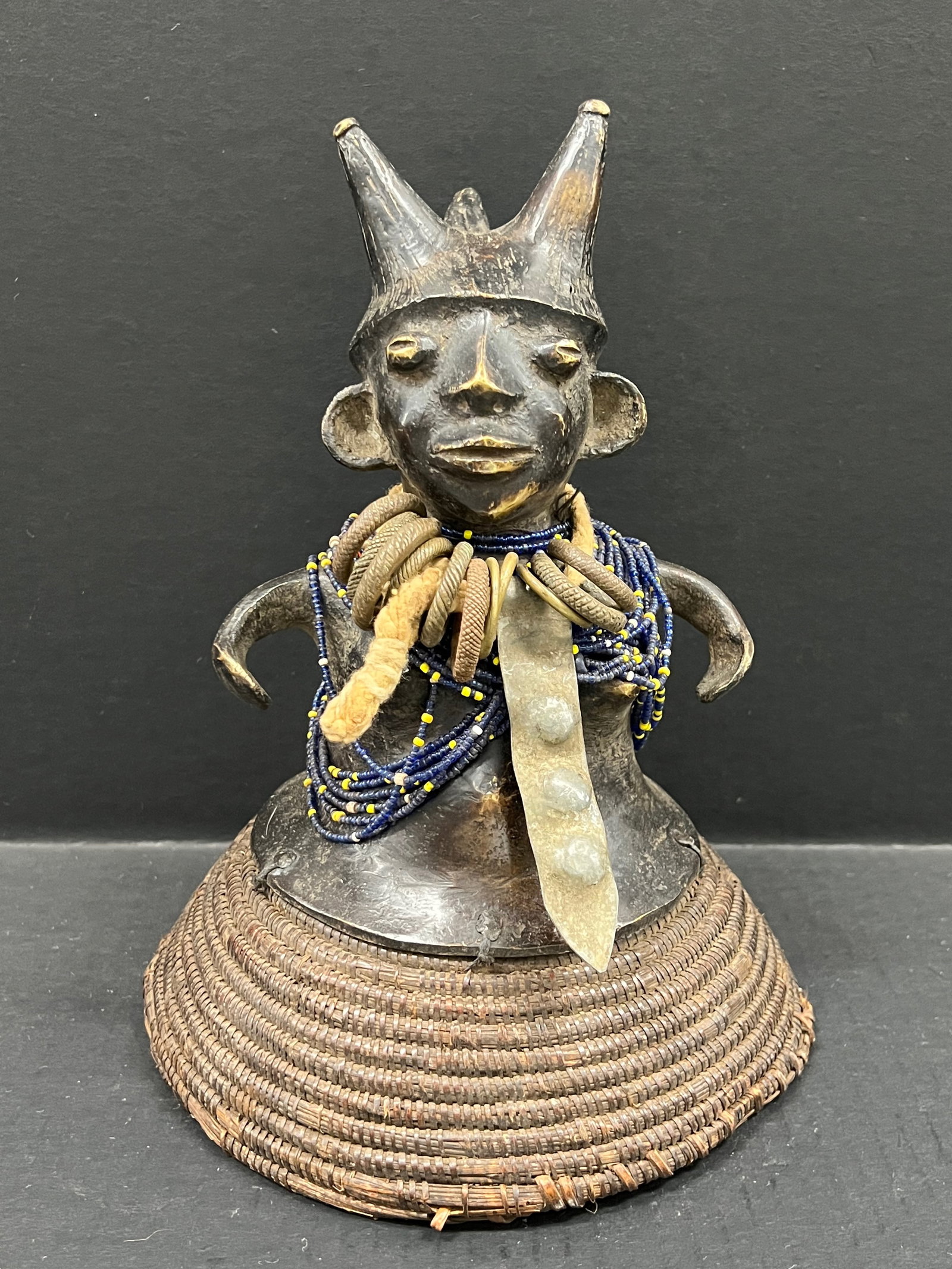 Carved Wood Benin Bronze Headdress: African Tribal Art Benin Bronze Headdress. The dimension is 11 inches high x 8.5 inches wide. Please be aware that some of the items are vintage, secondhand, old ages, antiques and may have a defects