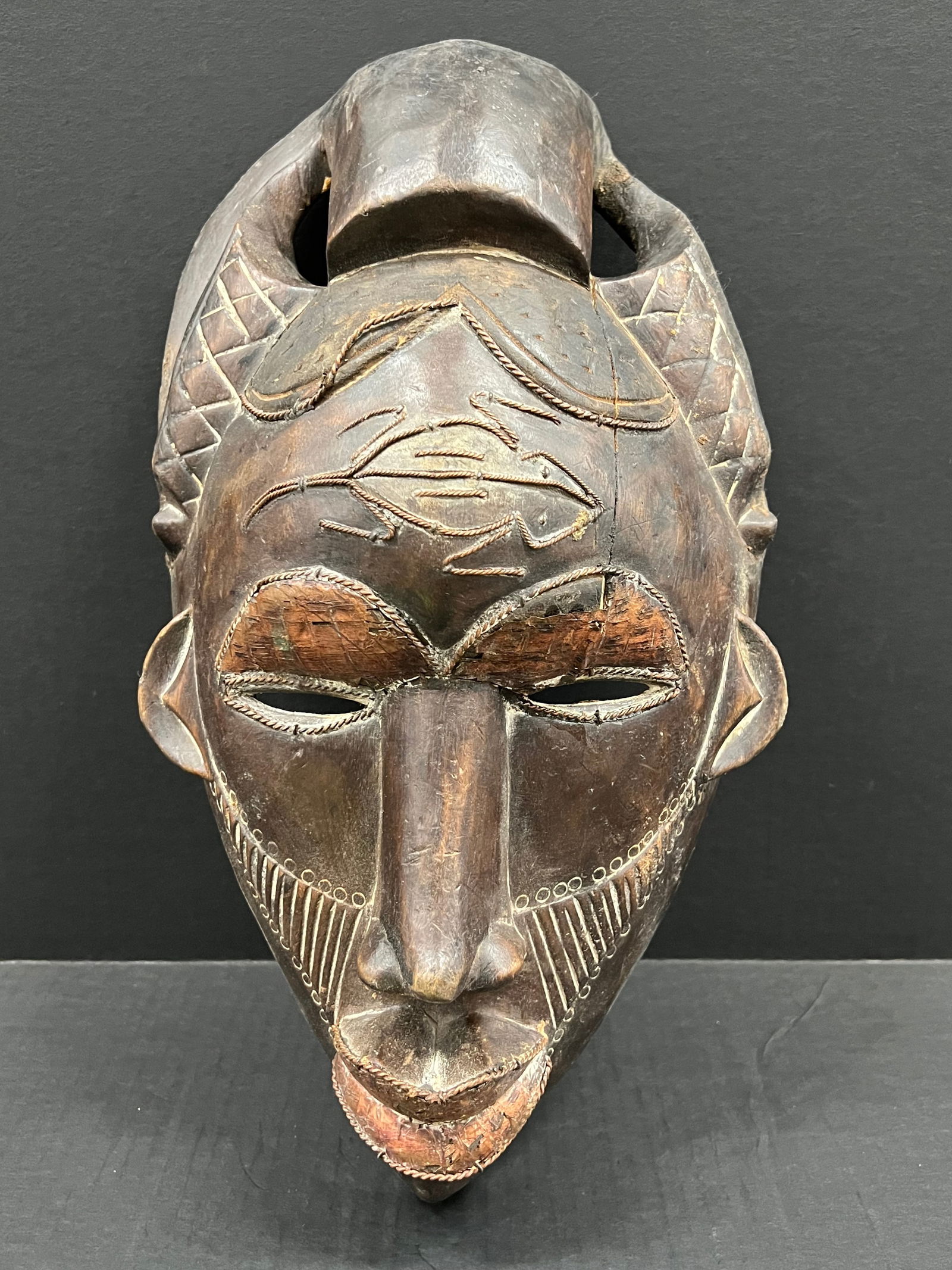 Carved Wood Tikar Mask: African Tribal Art Carved Wood Tikar Mask. The dimension is 17 inches high x 9.5 inches wide. Please be aware that some of the items are vintage, secondhand, old ages, antiques and may have a defects