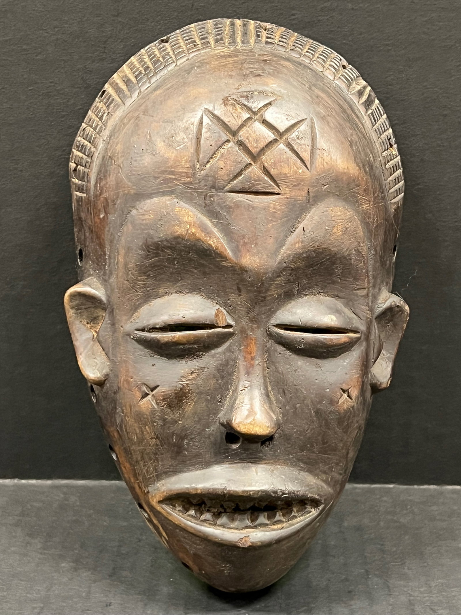 Carved Wood Chokwe Mask: African Tribal Art Carved Wood Chokwe Mask. The dimension is 9.5 inches high x 5.5 inches wide. Please be aware that some of the items are vintage, secondhand, old ages, antiques and may have a defect