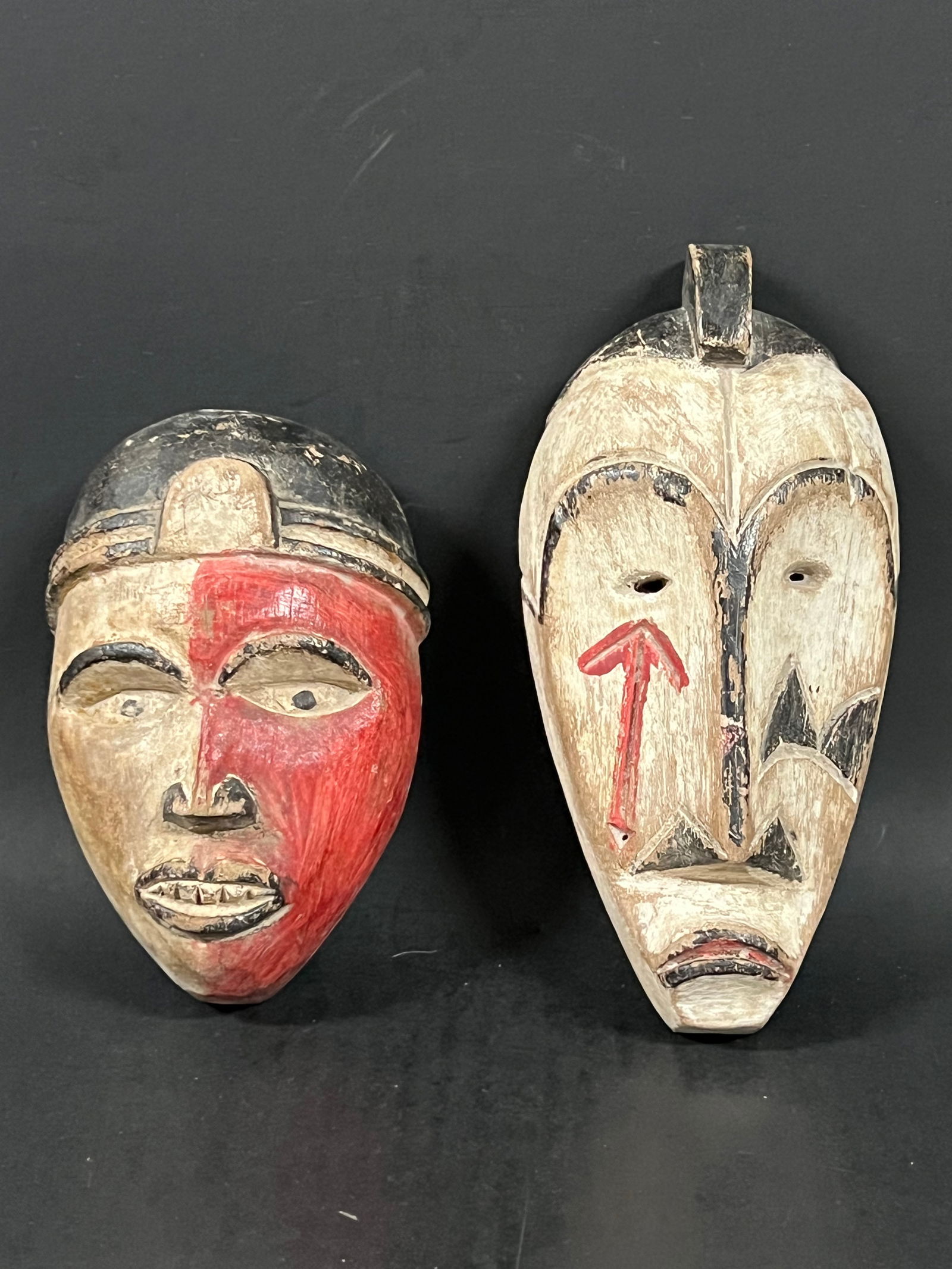 Passport Mask 2 pieces: African Tribal Art Passport Mask. The dimension is 5.75 inches high x 4 inches wide and 7.5 inches high x 3.75 inches wide. Please be aware that some of the items are vintage, secondhand, old ages, an