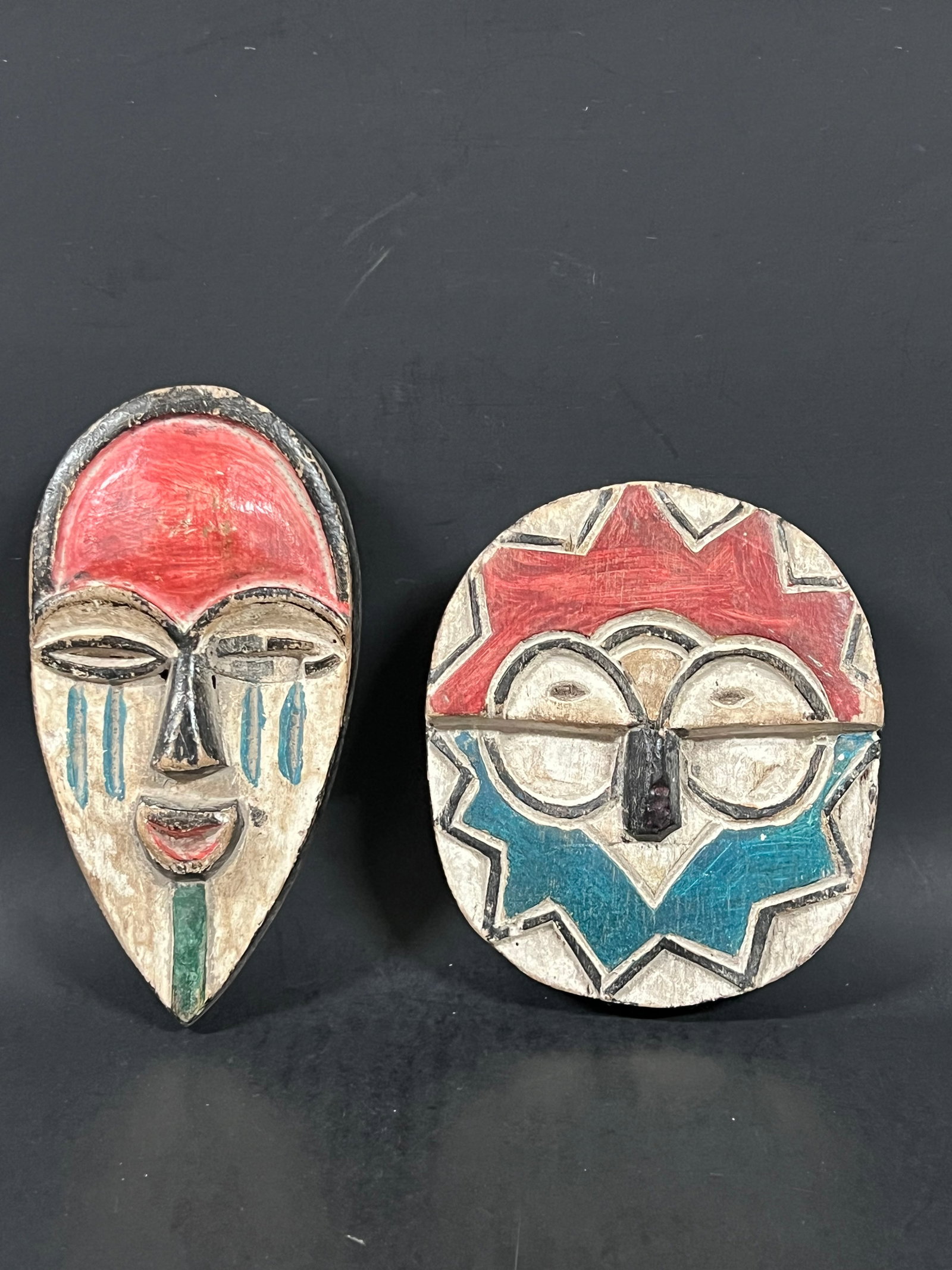 Passport Mask 2 pieces: African Tribal Art Passport Mask. The dimension is 5.75 inches high x 4 inches wide and 7.5 inches high x 3.75 inches wide. Please be aware that some of the items are vintage, secondhand, old ages, an