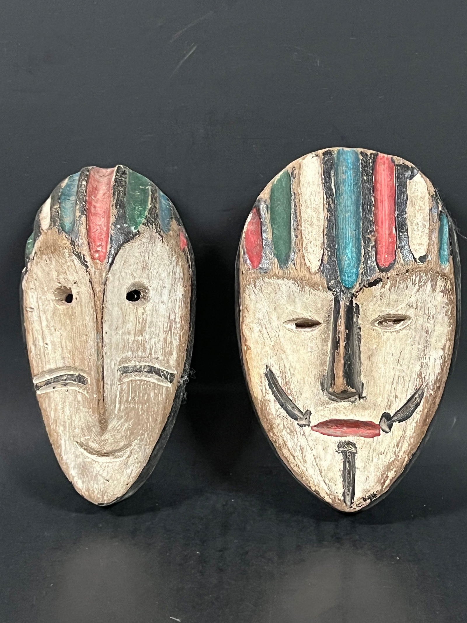 Passport Mask 2 pieces: African Tribal Art Passport Mask. The dimension is 5.75 inches high x 4 inches wide and 7.5 inches high x 3.75 inches wide. Please be aware that some of the items are vintage, secondhand, old ages, an