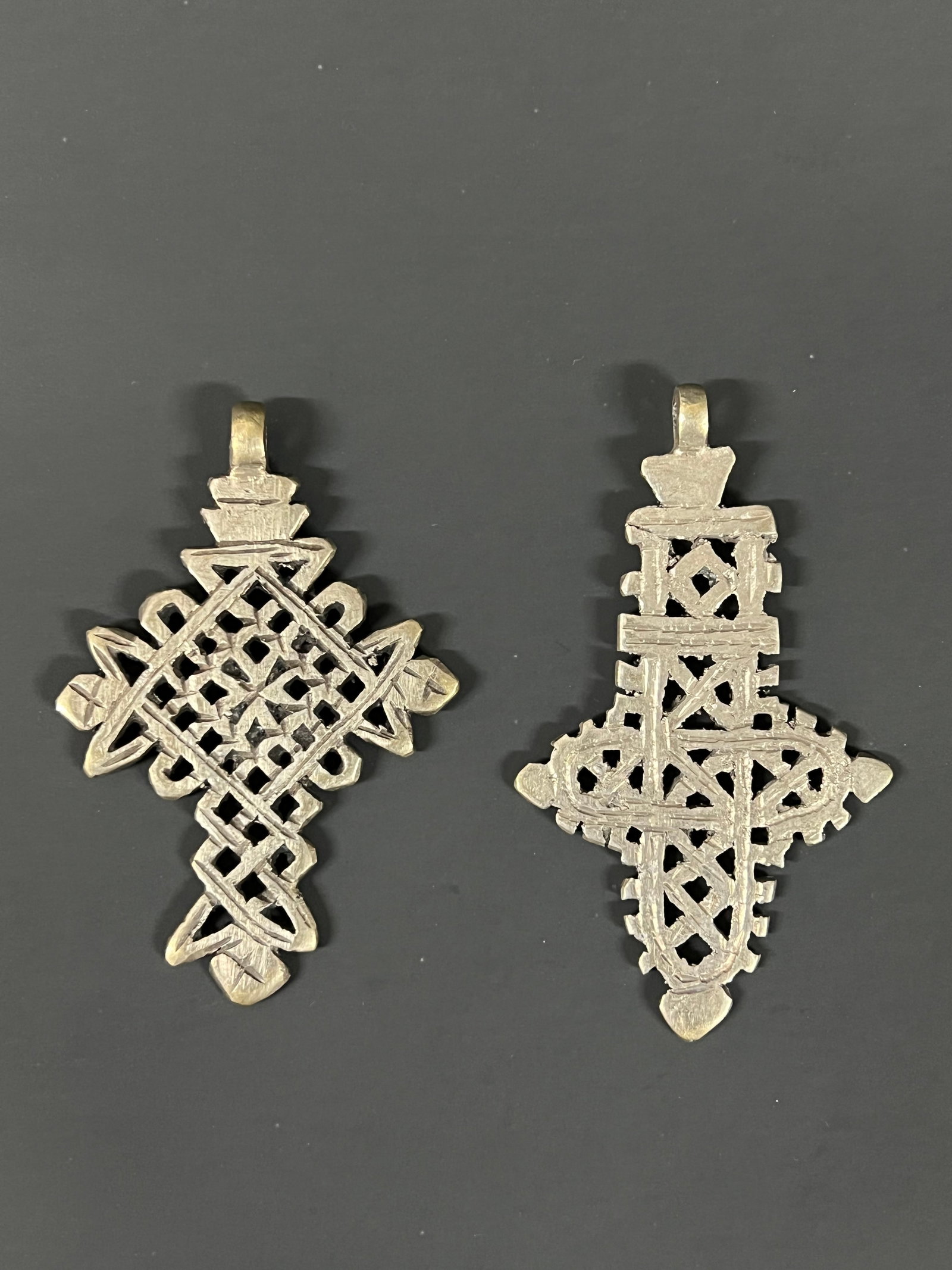 Ethiopian Coptic Cross Pendant 2 pieces: African Tribal Art Ethiopian Coptic Cross Pendant 2 pieces. The dimension is 3.25 inches high x 2.25 inches wide and 3.5 inches high x 2 inches wide. Please be aware that some of the items are