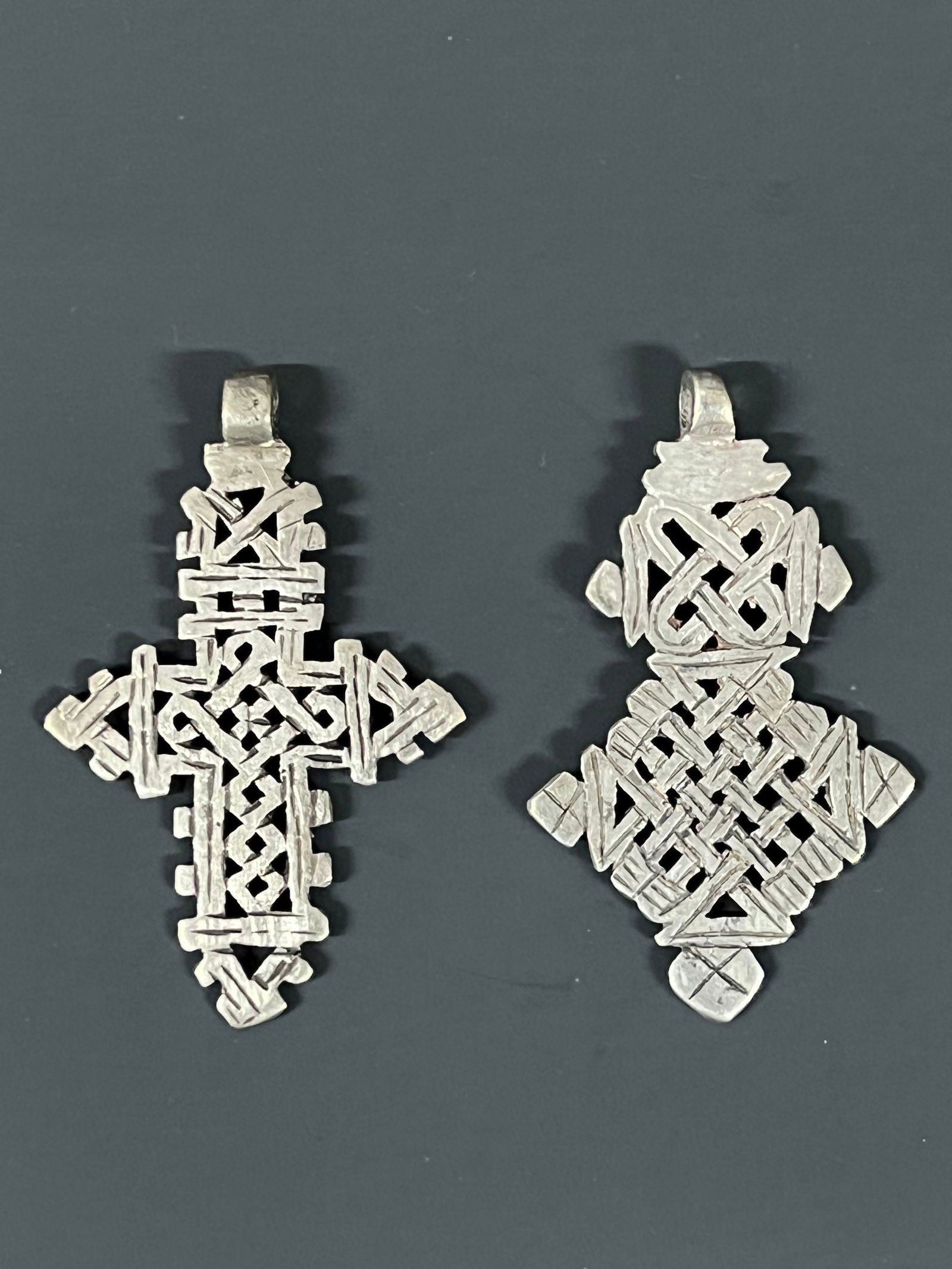 Ethiopian Coptic Cross Pendant 2 pieces: African Tribal Art Ethiopian Coptic Cross Pendant 2 pieces. The dimension is 3.5 inches high x 2.25 inches wide and 3.5 inches high x 2 inches wide. Please be aware that some of the items are vintage,