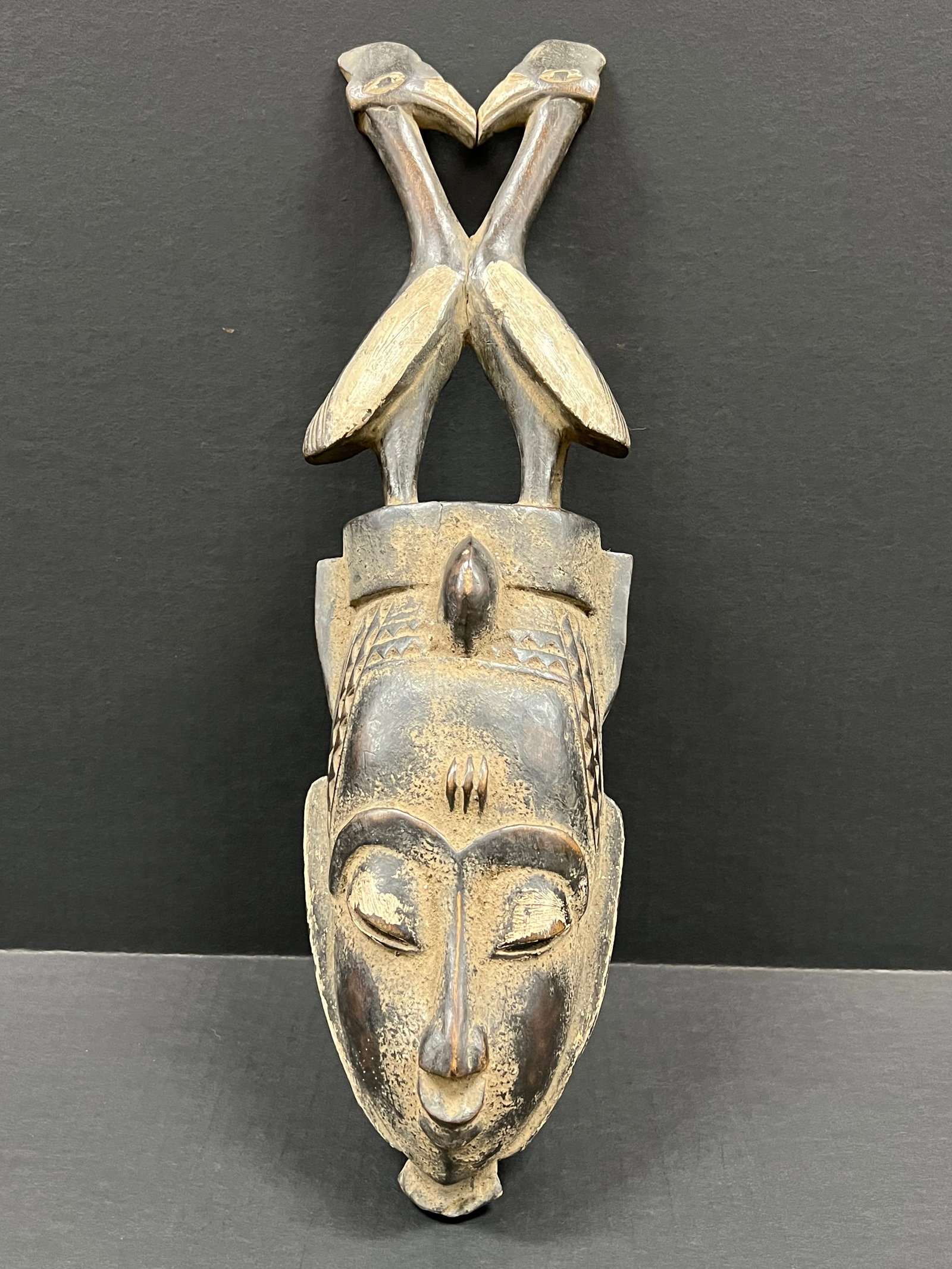 Baule Mask: African Tribal Art Baule Mask. The dimension is 17 inches high x 5 inches wide. Please be aware that some of the items are vintage, secondhand, old ages, antiques and may have a defects or sign of