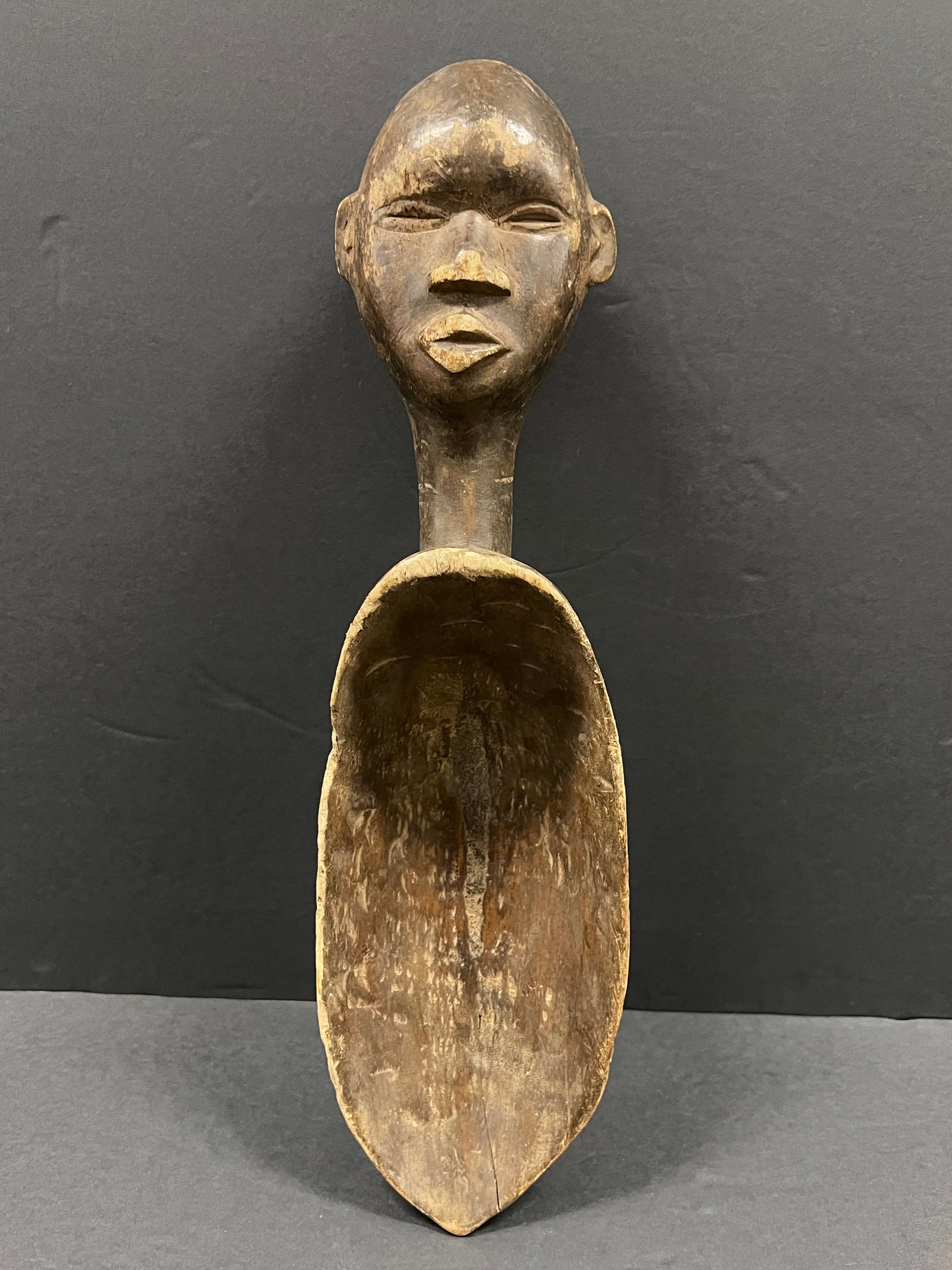 Dan Wooden Spoon: African Tribal Art Dan Wooden Spoon. The dimension is 17.5 inches high x 5 inches wide. Please be aware that some of the items are vintage, secondhand, old ages, antiques and may have a defects or sig