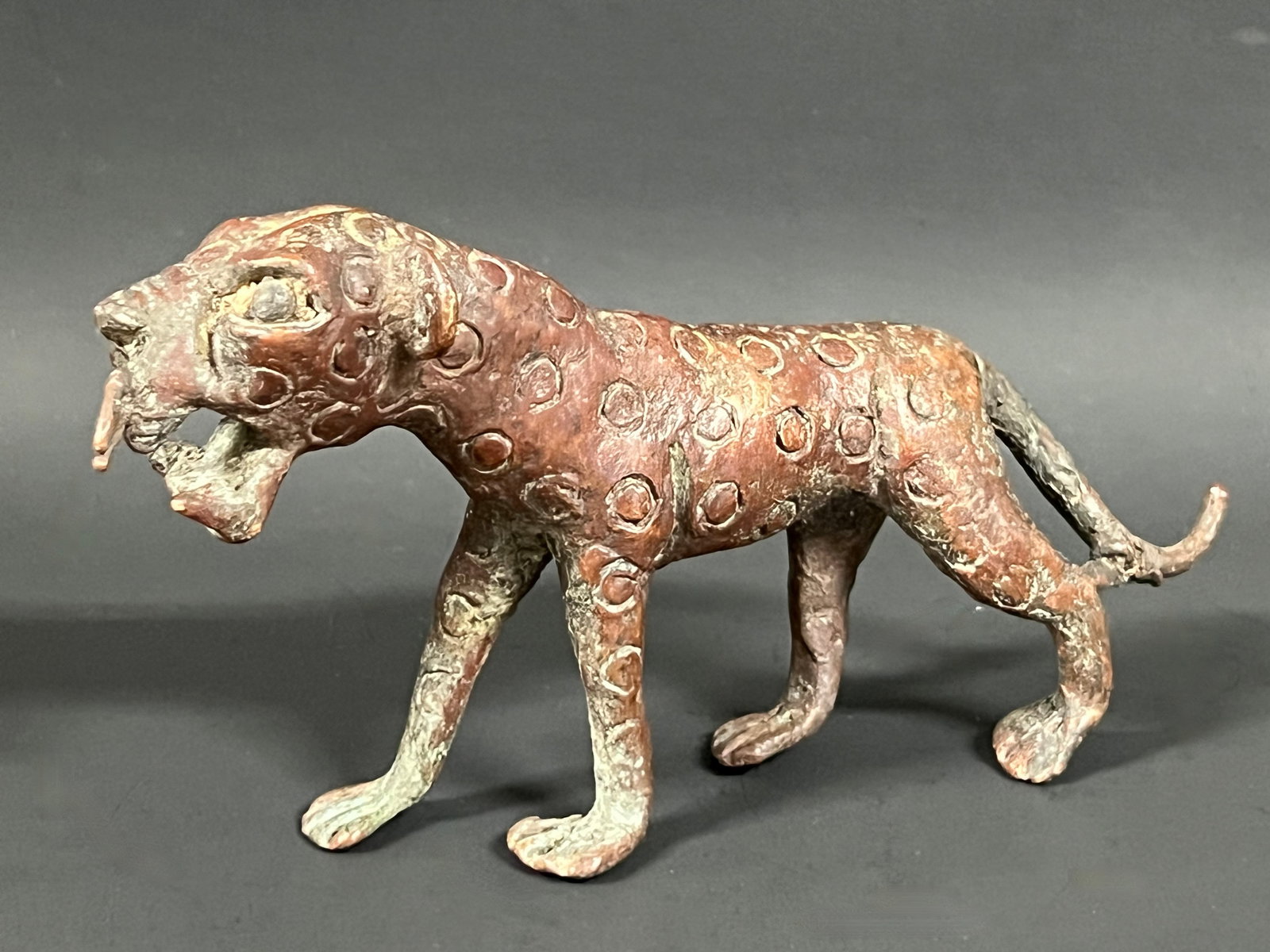 Bronze Leopard Sculpture: African Tribal Art Bronze Leopard Sculpture. The dimension is 4 inches high x 7.5 inches depth x 1.5 inches wide. Please be aware that some of the items are vintage, secondhand, old ages, antiques and