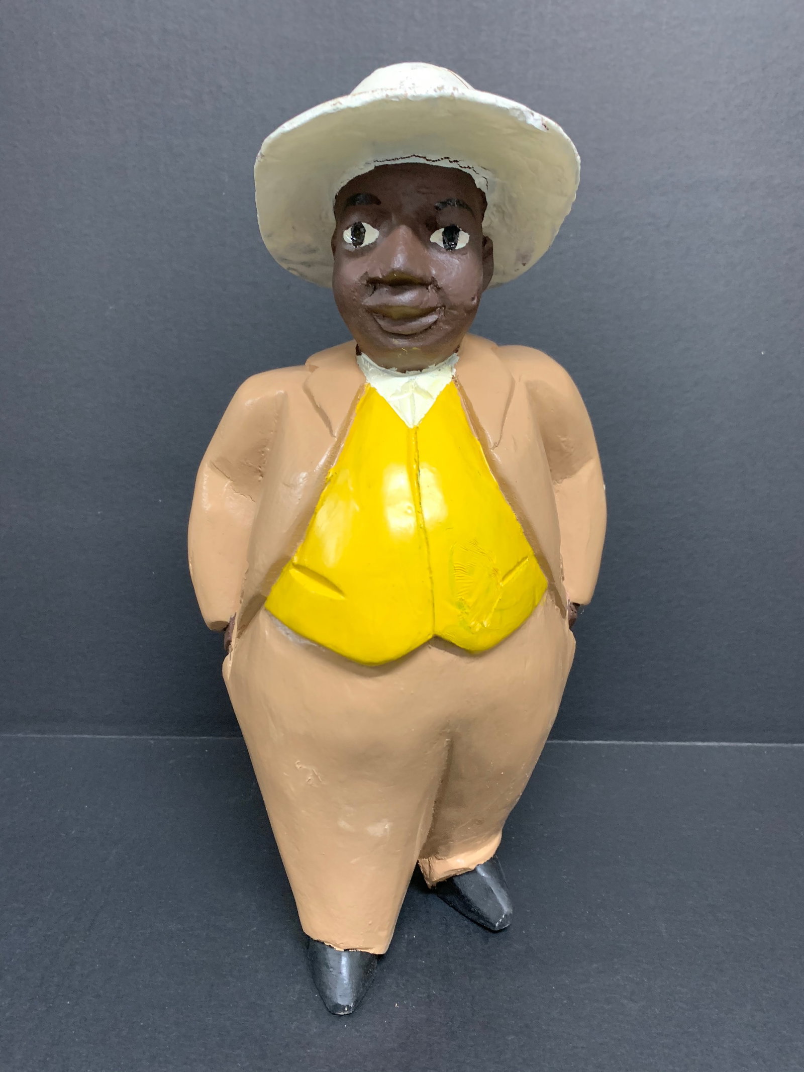 Male Colonial Statue: African Tribal Art Male Colonial Statue. The dimension is 13 inches high x 8 inches wide. Please be aware that some of the items are vintage, secondhand, old ages, antiques and may have a defects or s