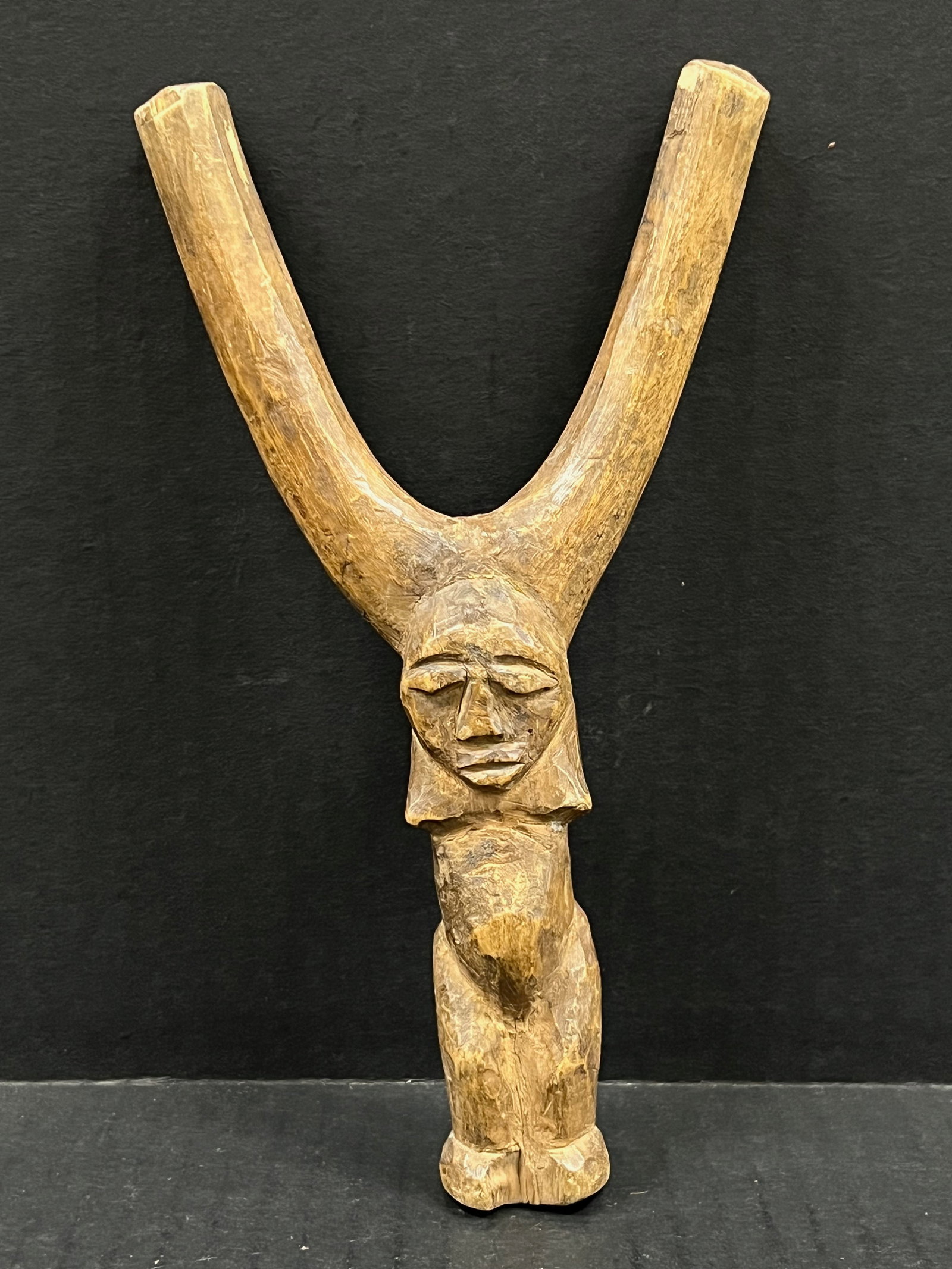 Carved Wood Dogon Slingshot: African Tribal Art Carved Wood Dogon Slingshot. The dimension is 8 inches high x 4.5 inches wide. Please be aware that some of the items are vintage, secondhand, old ages, antiques and may have a