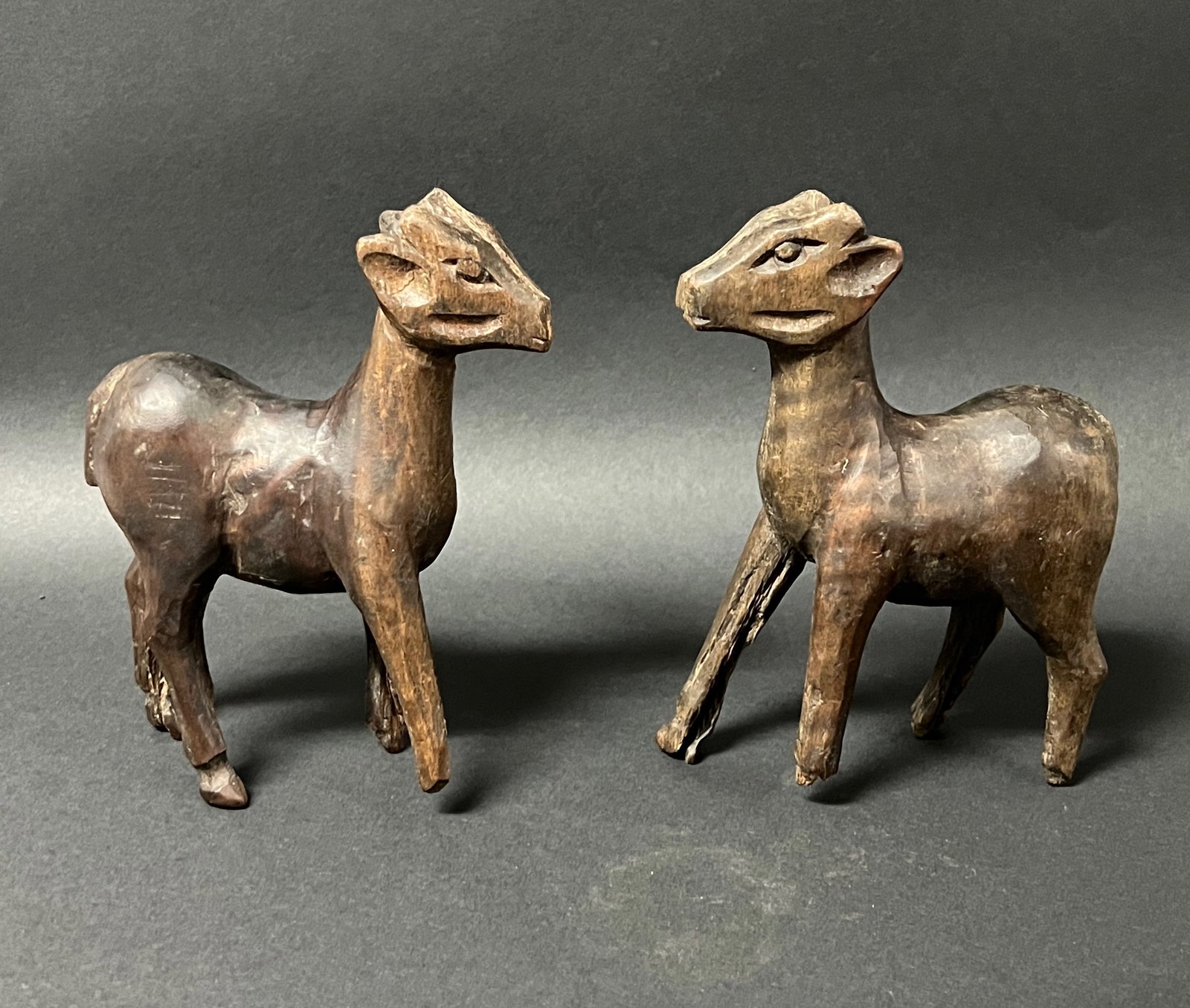 Folk Art Carved Wood Deer Sculpture 2 pieces: Folk Art Carved Wood Deer Sculpture. The dimension is 6.75 inches high x 5 inches wide. Please be aware that some of the items are vintage, secondhand, old ages, antiques and may have a defects or