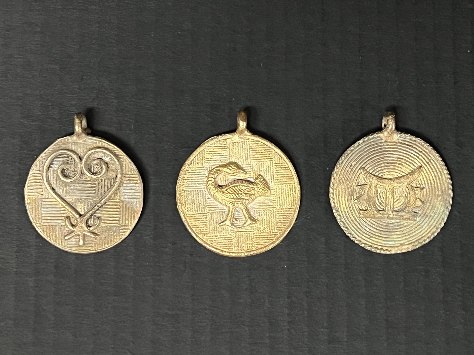 Ashanti Brass Pendant Lot of 3: African Tribal Art Ashanti Brass Pendant Lot of 3. The dimension is 2.5 inches high x 2 inches wide. Please be aware that some of the items are vintage, secondhand, old ages, antiques and may have a