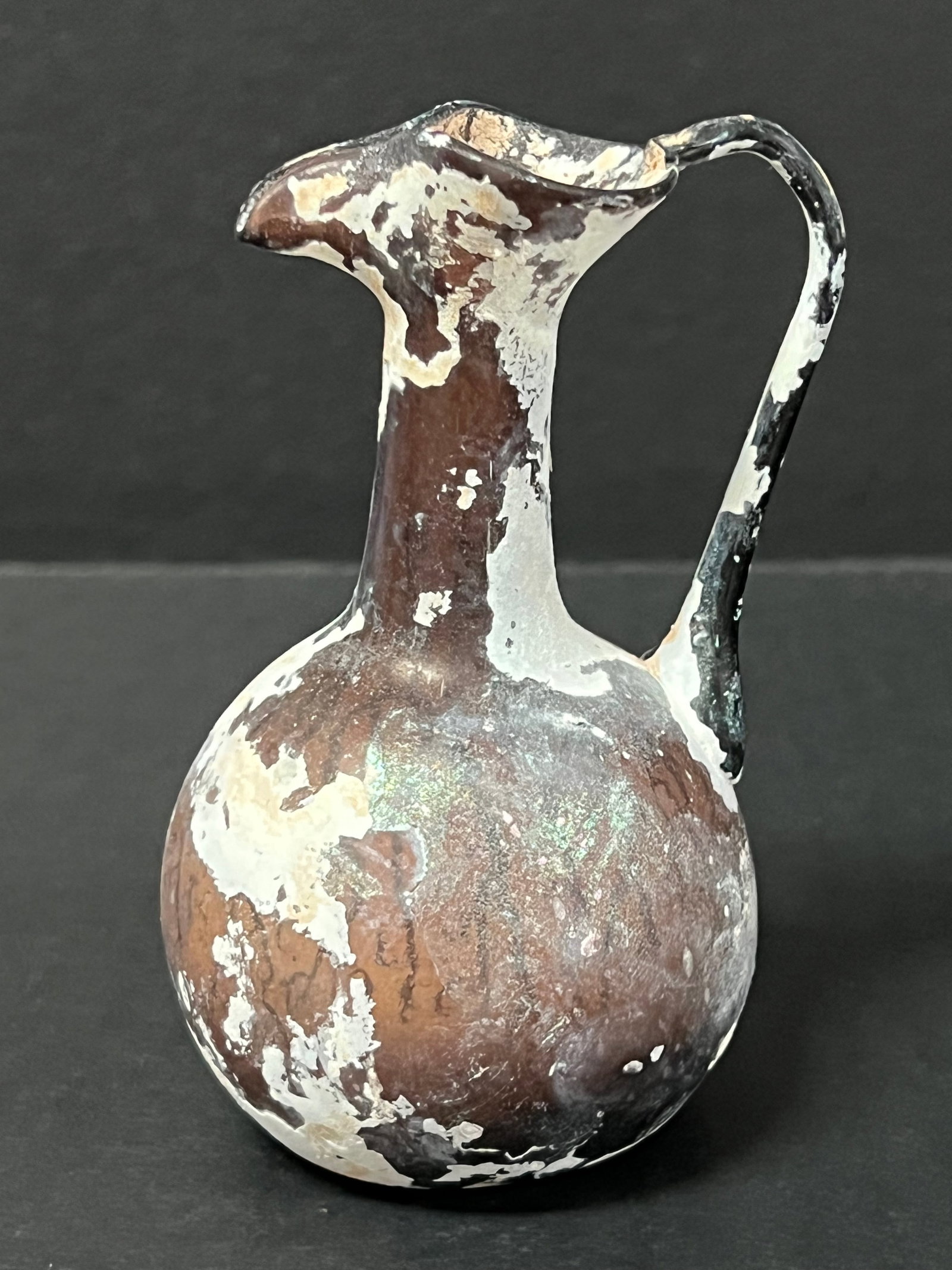 Roman Art Style Glass Bottle: Roman Art Style Glass Bottle. The dimension is 4 inches high x 2.5 inches wide. Please be aware that some of the items are vintage, secondhand, old ages, antiques and may have a defects or sign of age