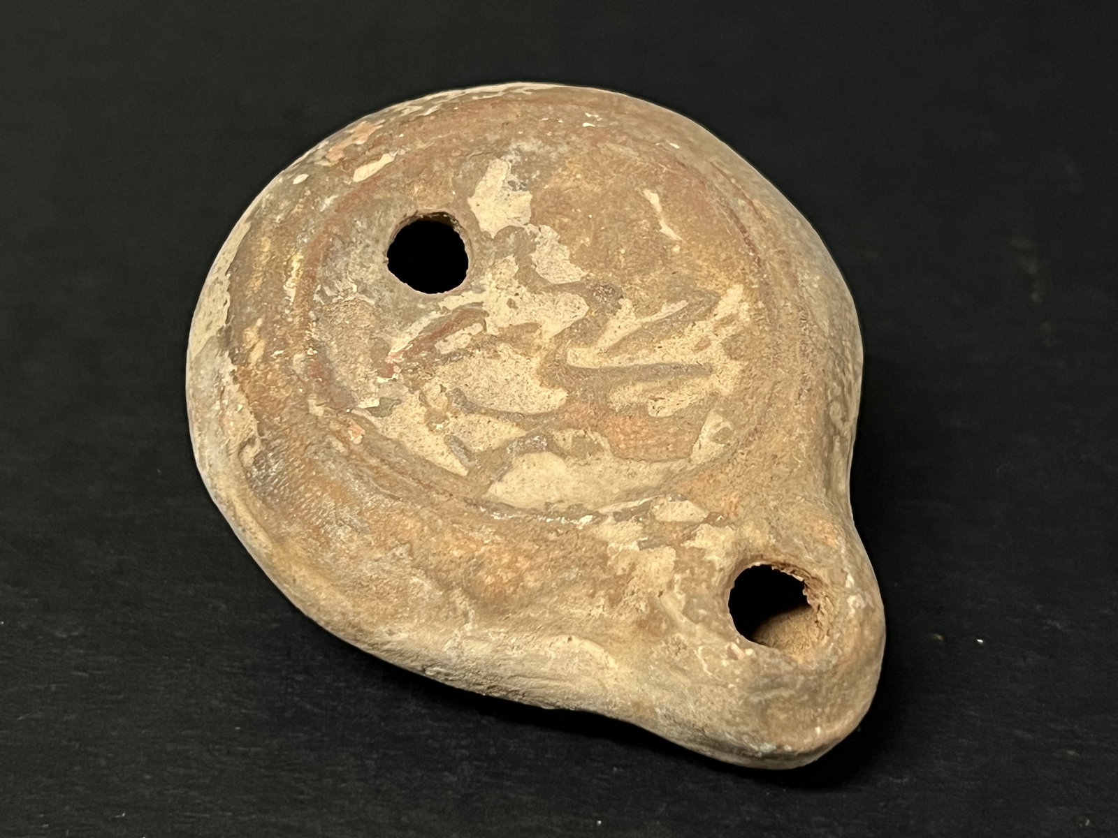 Vintage Terra Cotta Oil Lamp: Vintage Terra Cotta Oil Lamp. The dimension is 1 inches high x 2 inches wide. Please be aware that some of the items are vintage, secondhand, old ages, antiques and may have a defects or sign of