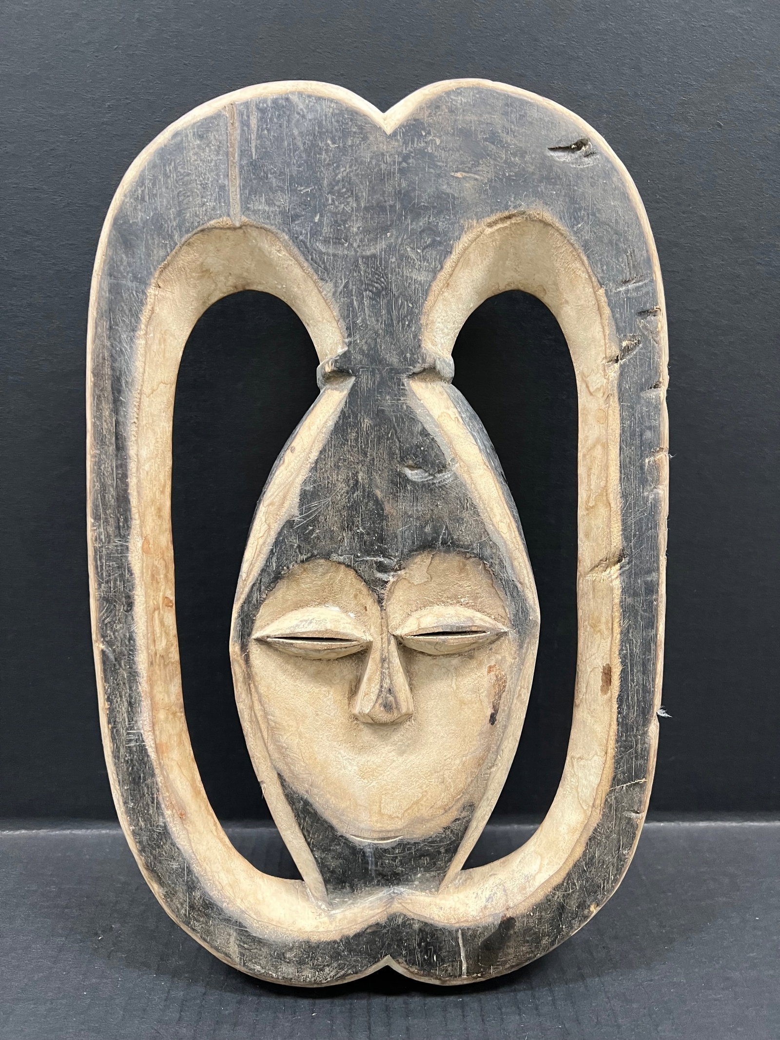 Kwele Mask: African Tribal Art Kwele Mask. The dimension is 15.5 inches high x 10 inches wide. Please be aware that some of the items are vintage, secondhand, old ages, antiques and may have a defects or sign of