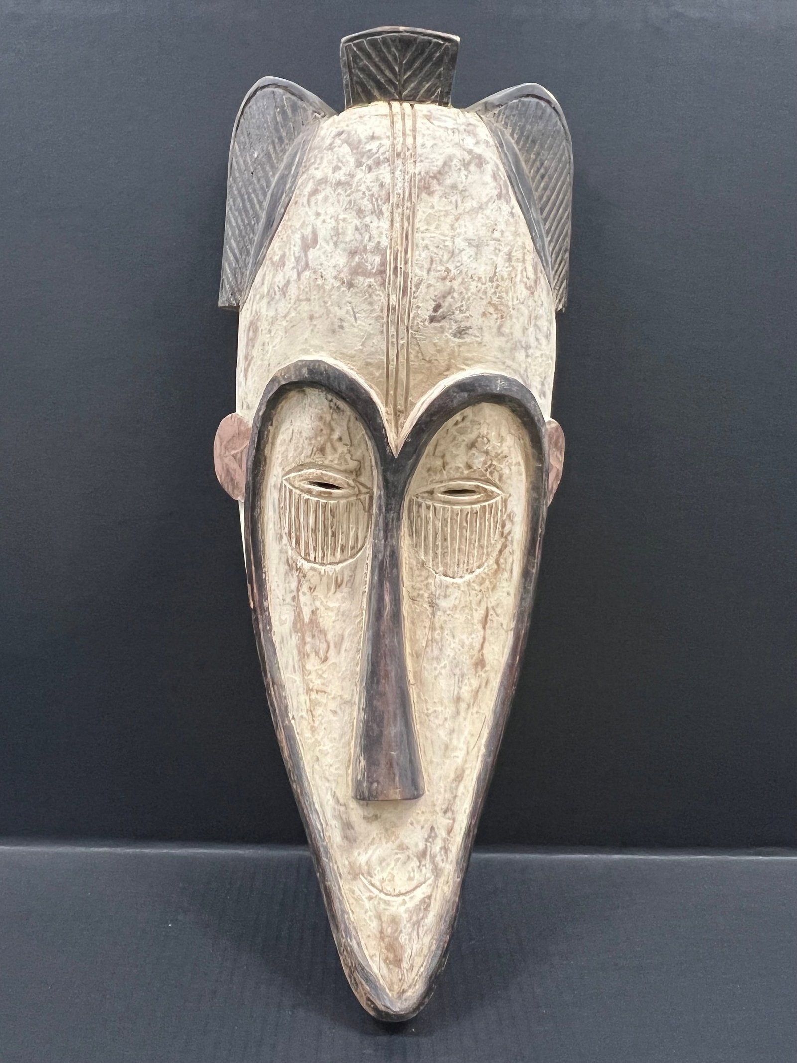 Fang Mask: African Tribal Art Fang Mask. The dimension is 23 inches high x 9 inches wide. Please be aware that some of the items are vintage, secondhand, old ages, antiques and may have a defects or sign of