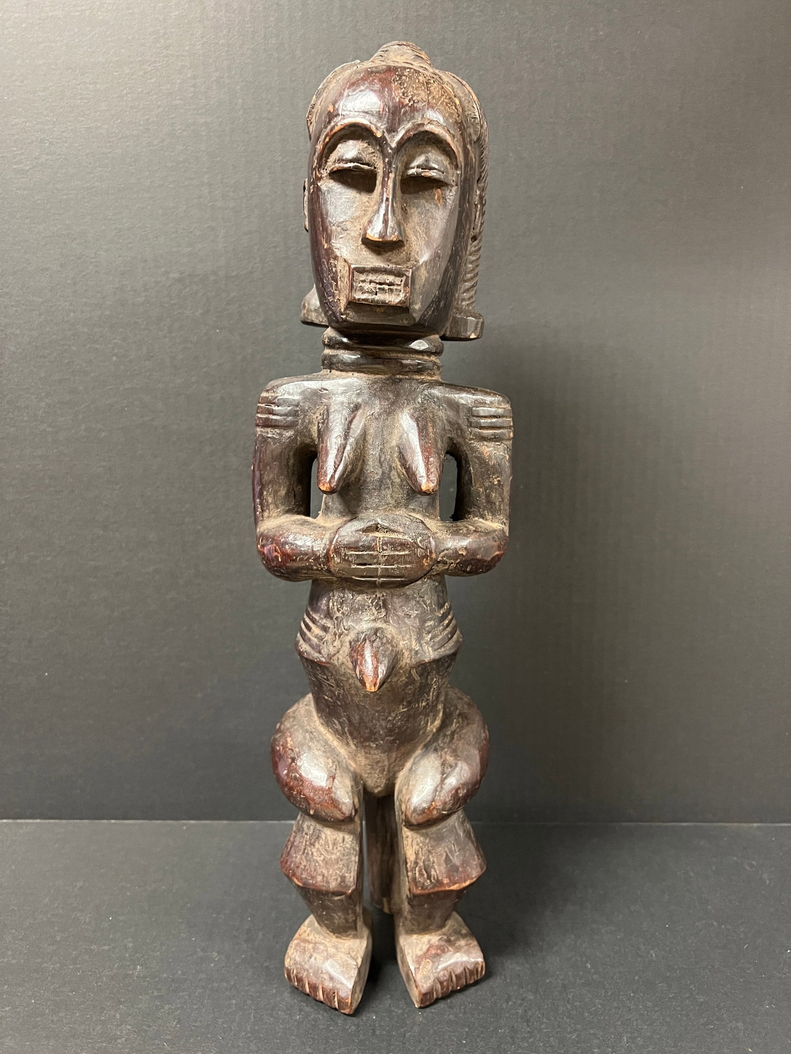 Fang Statue: African Tribal Art Fang Statue. The dimension is 19.5 inches high x 5 inches wide. Please be aware that some of the items are vintage, secondhand, old ages, antiques and may have a defects or sign of