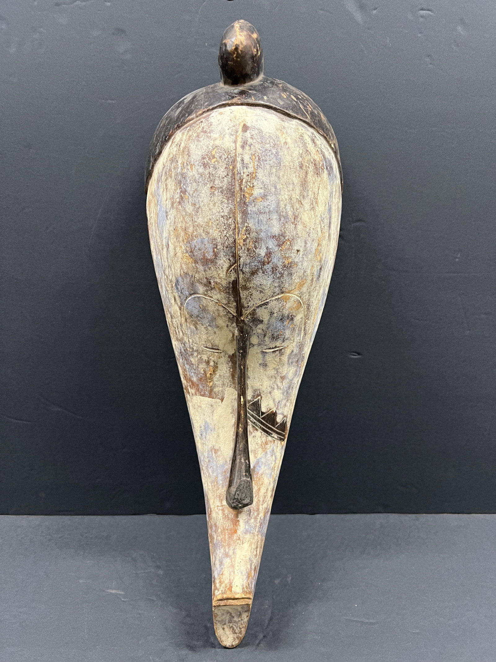 Fang Mask: African Tribal Art Fang Mask. The dimension is 22 inches high x 8.5 inches wide. Please be aware that some of the items are vintage, secondhand, old ages, antiques and may have a defects or sign of