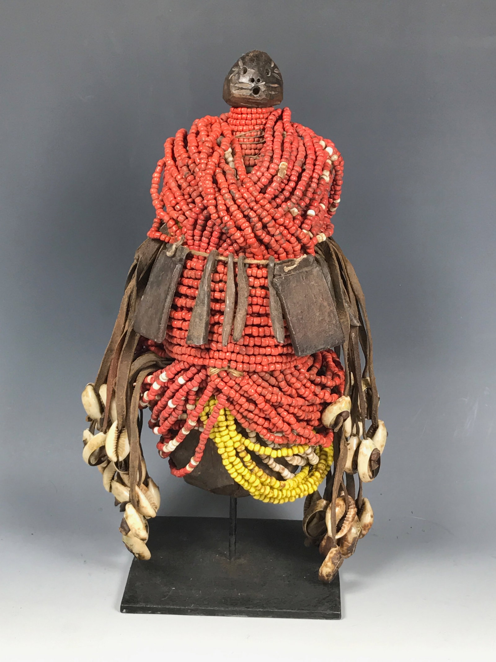 Carved Wood and Beaded Fertility Fall Doll with Display Stand: African Tribal Art Carved Wood and Beaded Fertility Doll with Display Stand. The dimension is 11.75 inches high x 7 inches wide. Please be aware that some of the items are vintage, secondhand, old