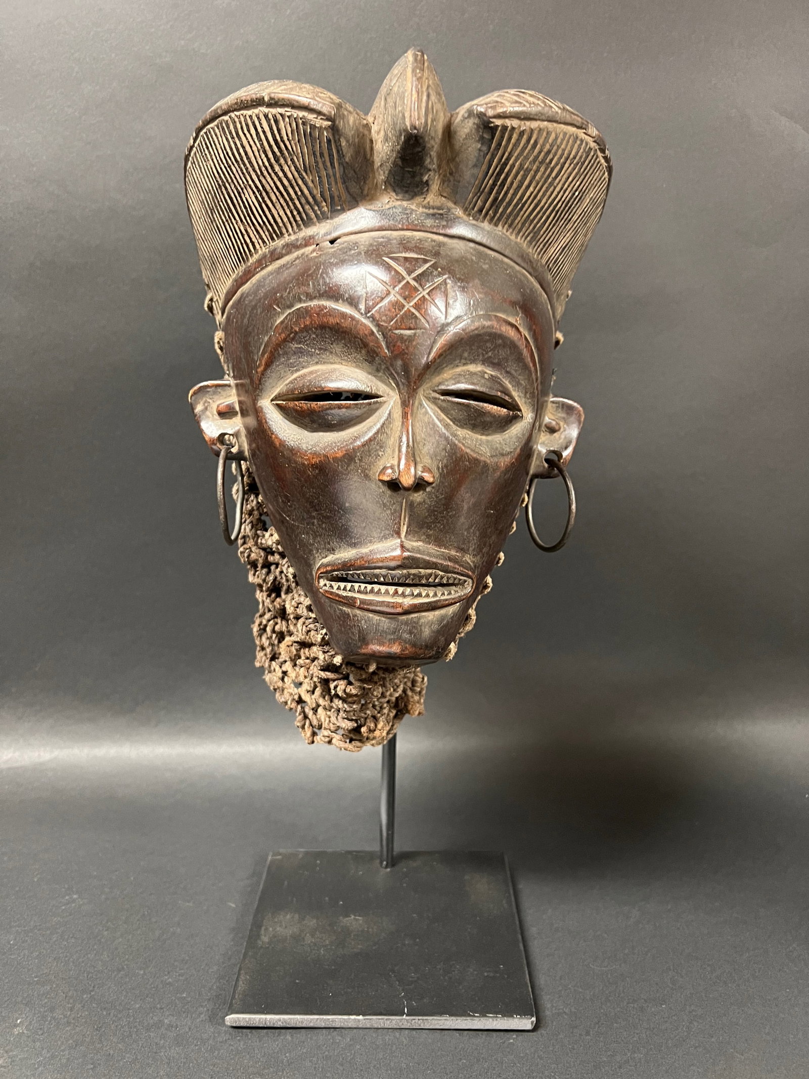 Carved Wood Chokwe Mask with Display Stand: African Tribal Art Carved Wood Chokwe Mask with Display Stand. The dimension is 16 inches high x 8 inches wide. Please be aware that some of the items are vintage, secondhand, old ages, antiques and m