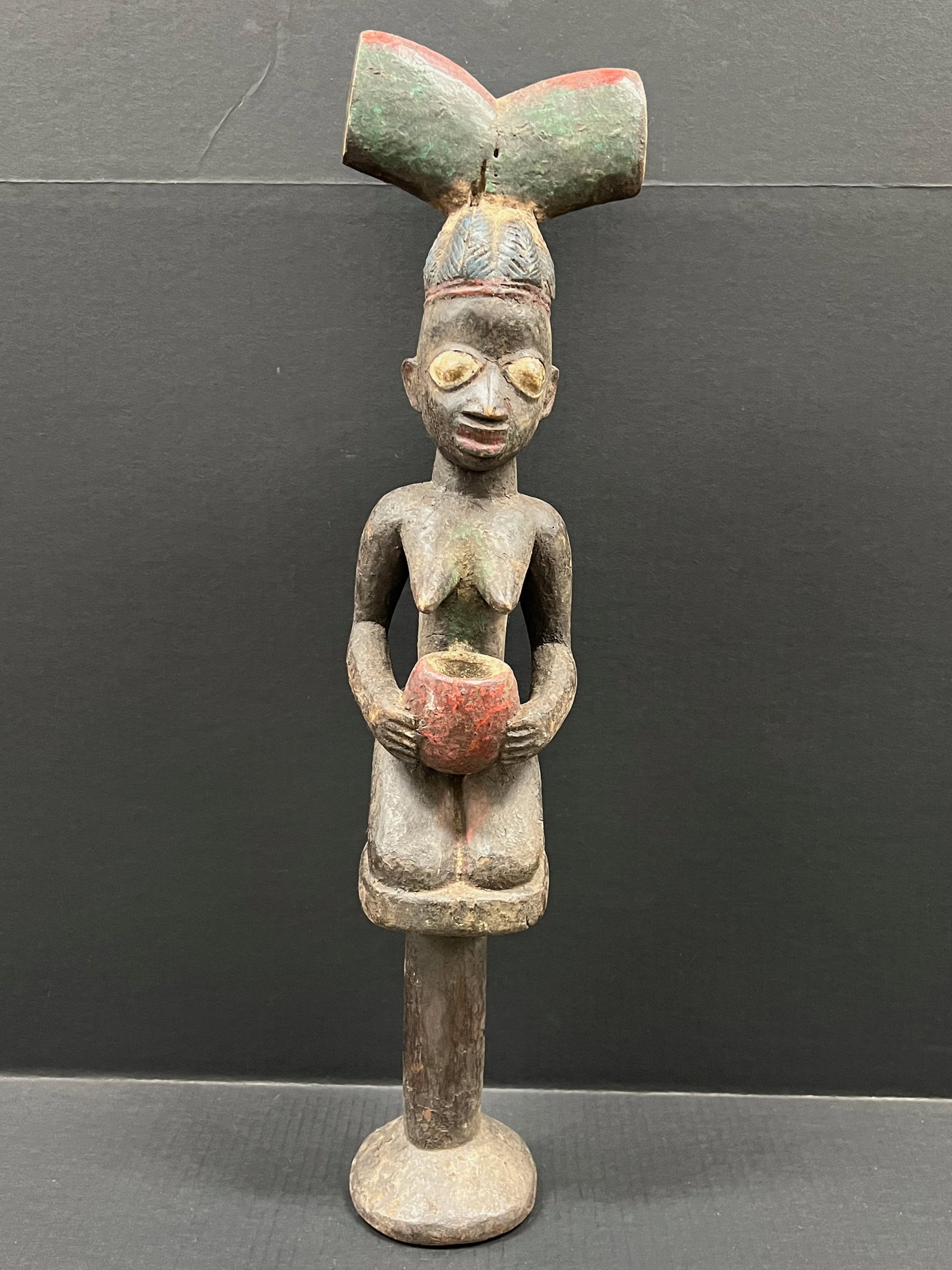 Carved Wood Yuroba Shango Statue: African Tribal Art Carved Wood Yuroba Shango Statue. The dimension is 27 inches high x 6.5 inches wide. Please be aware that some of the items are vintage, secondhand, old ages, antiques and may have