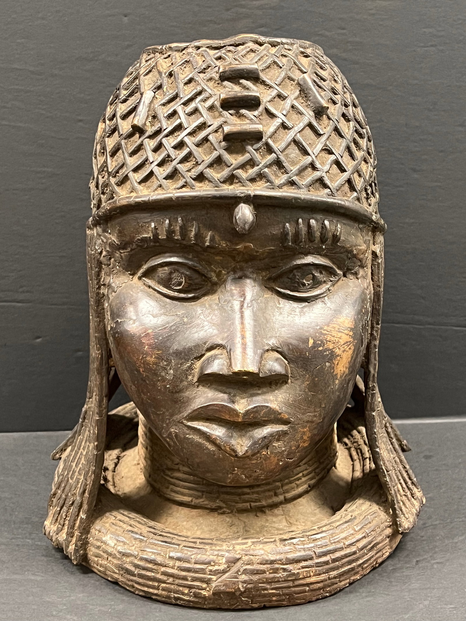 Benin Bronze Head Sculpture: African Tribal Art Benin Bronze Head Sculpture. The dimension is 14 inches high x 11.5 inches wide. Please be aware that some of the items are vintage, secondhand, old ages, antiques and may have a de