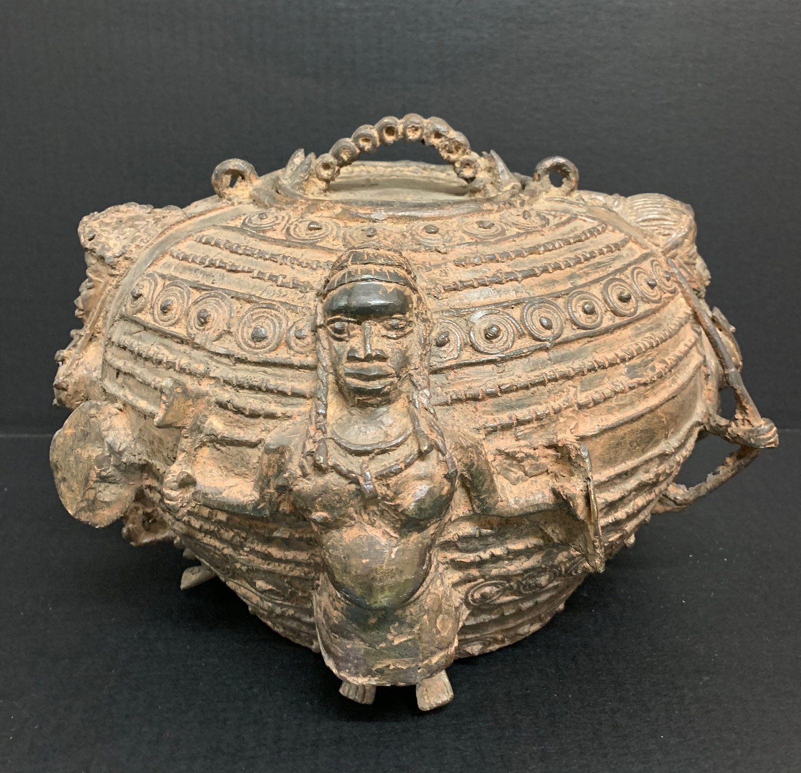 Benin Bronze Divination Container Sculpture: African Tribal Art Benin Bronze Divinition Container Sculpture. The dimension is 10 inches high x 13 inches wide. Please be aware that some of the items are vintage, secondhand, old ages, antiques