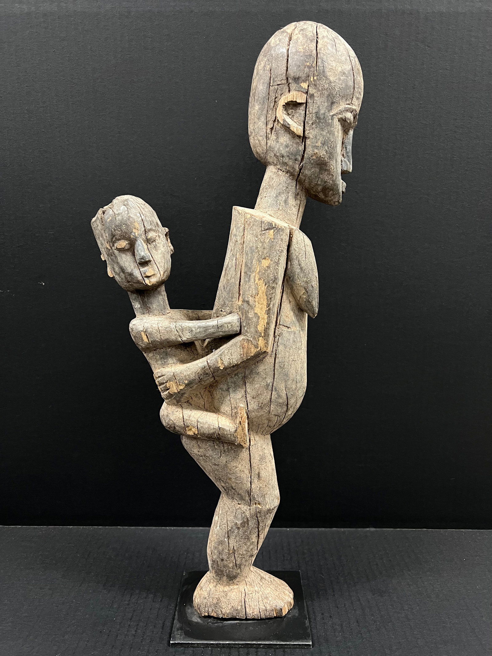 Carved Wood Lobi Maternity Statue: African Tribal Art Carved Wood Maternity Statue. The dimension is 21.5 inches high x 9.5 inches wide. Please be aware that some of the items are vintage, secondhand, old ages, antiques and may have a