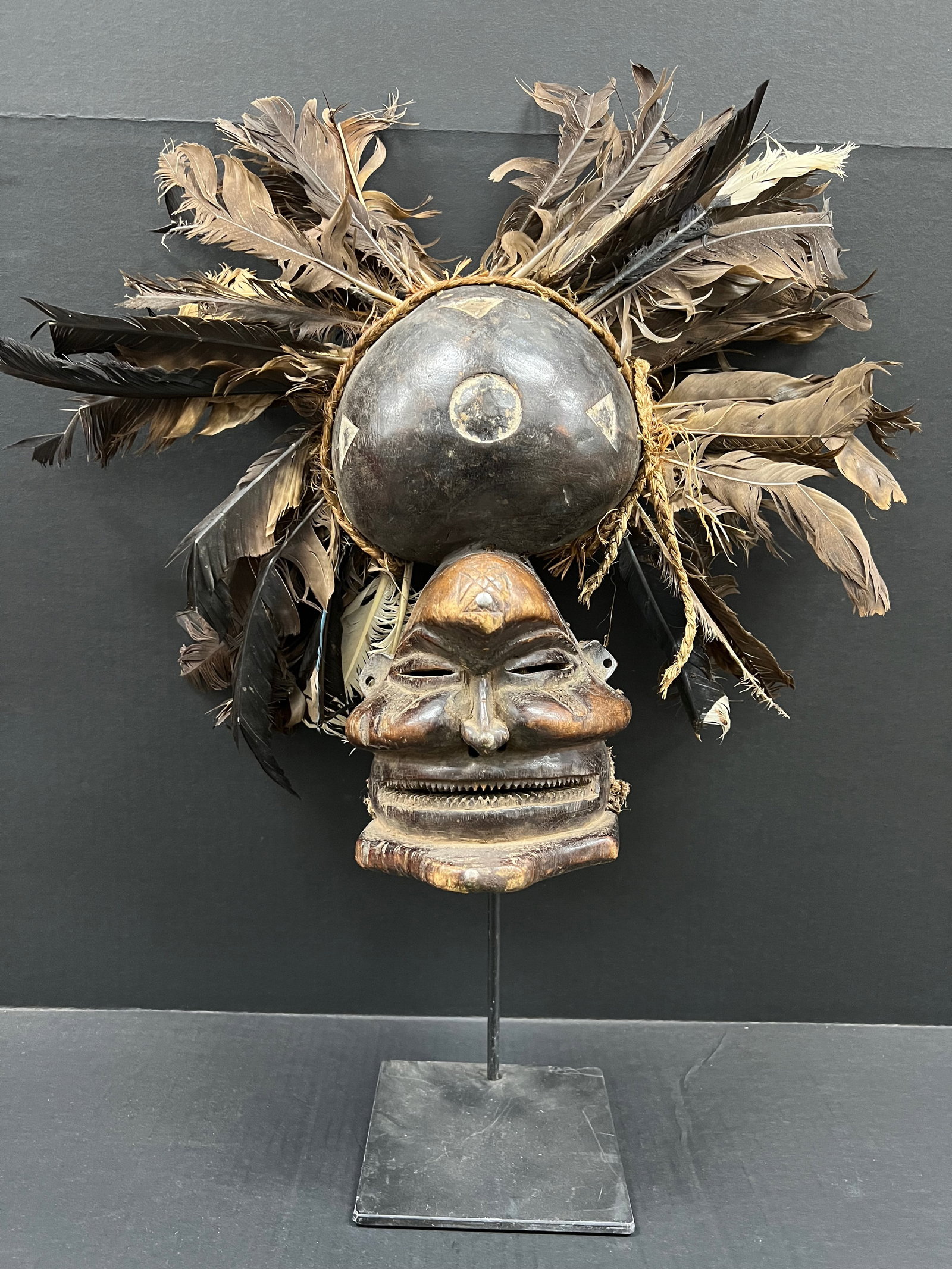 Chokwe Mask with Display Stand: African Tribal Art Carved Wood Chokwe Mask with Display Stand. The dimension is 25 inches high x 20 inches wide. Please be aware that some of the items are vintage, secondhand, old ages, antiques and 