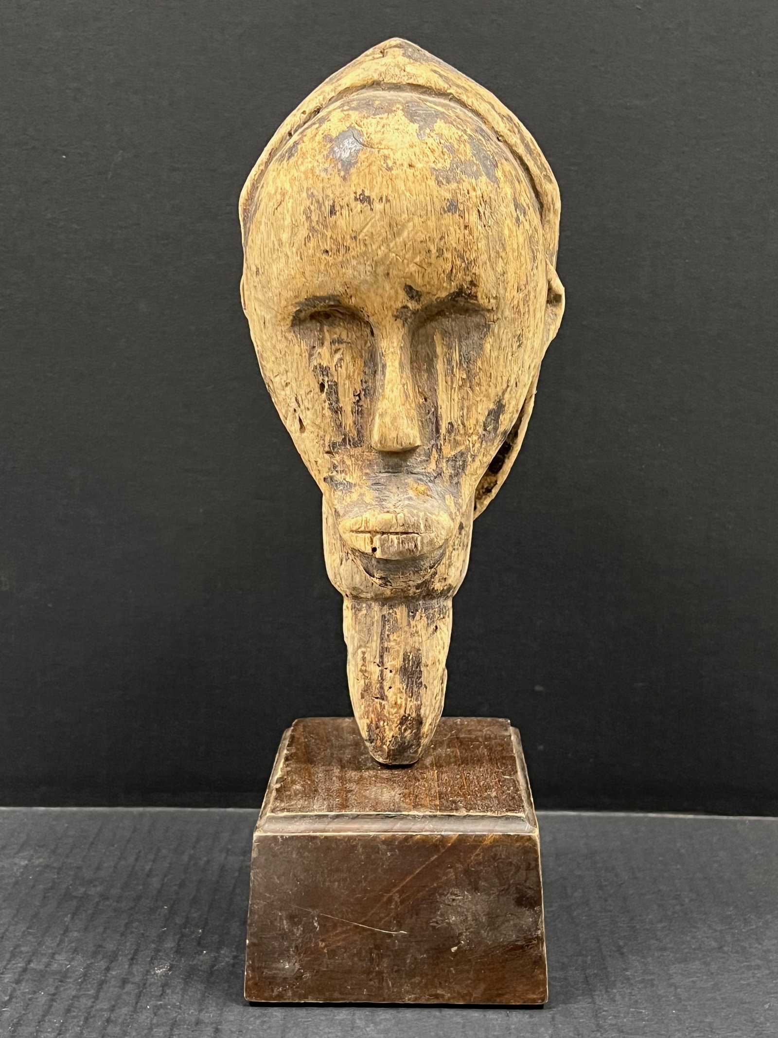 Carved Wood Fang Head with Display Stand: African Tribal Art Carved Wood Fang Head with Display Stand. The dimension is 14 inches high x 6.25 inches wide. Please be aware that some of the items are vintage, secondhand, old ages, antiques and 