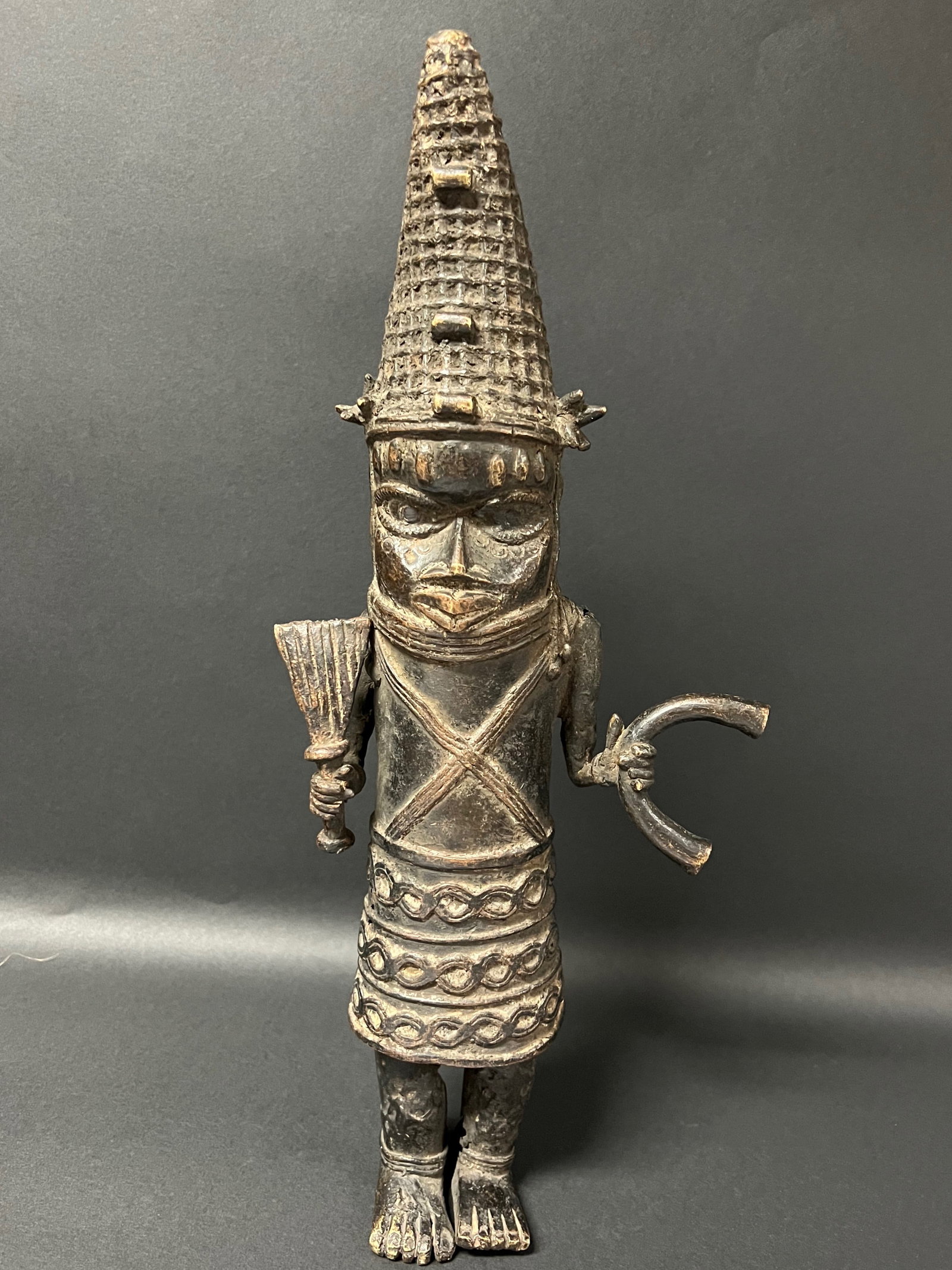 Benin Bronze Statue: African Tribal Art Benin Bronze Statue. The dimension is 17 inches high x 7.25 inches wide. Please be aware that some of the items are vintage, secondhand, old ages, antiques and may have a defects or