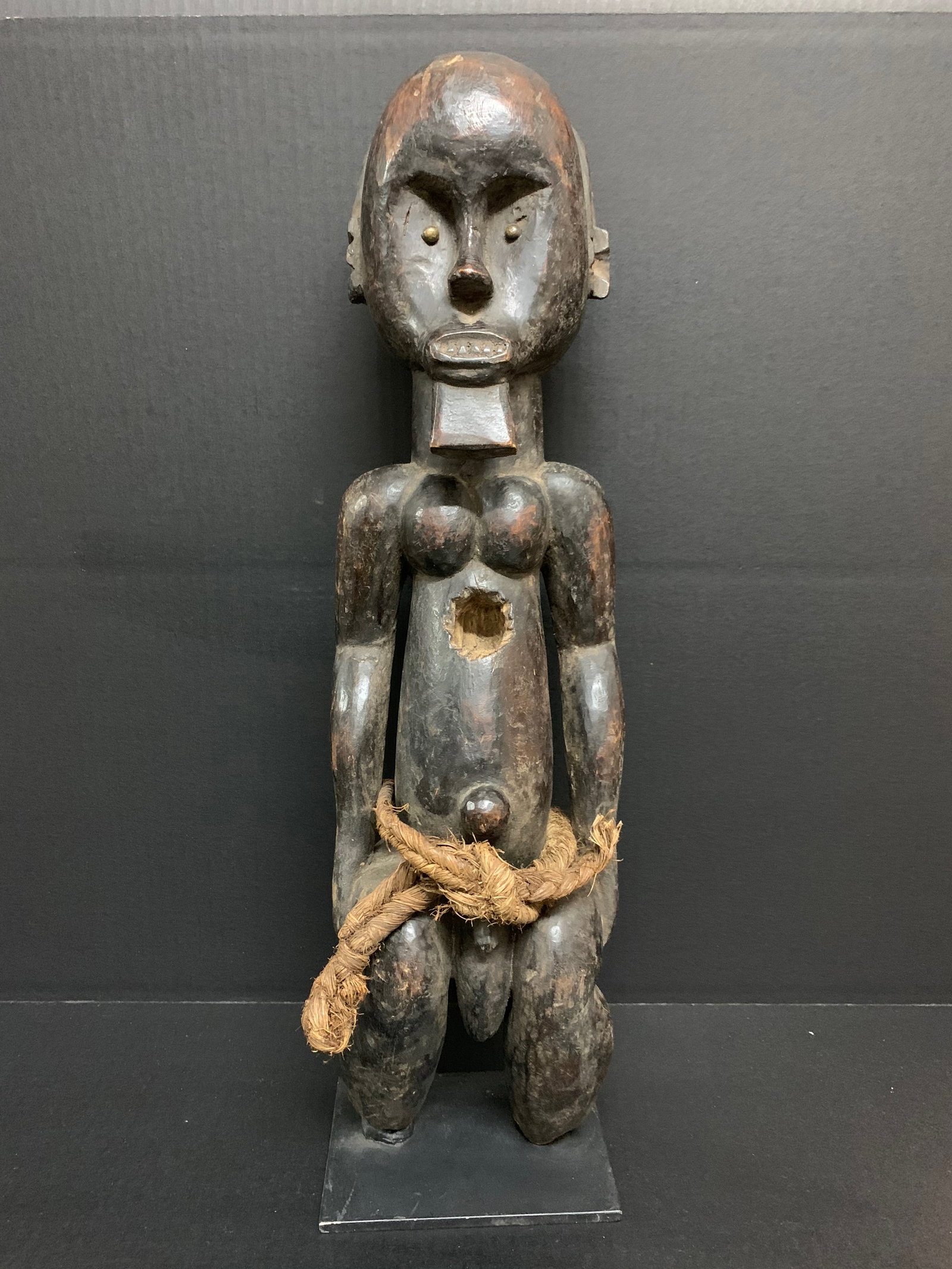 Carved Wood Fang Statue: African Tribal Art Carved Wood Fang Statue. The dimension is 22.5 inches high x 6.25 inches wide. Please be aware that some of the items are vintage, secondhand, old ages, antiques and may have a defe