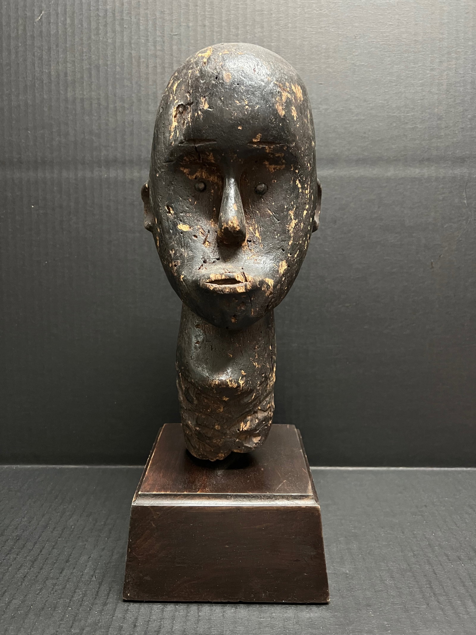 Carved Wood Fang Head with Display Stand: African Tribal Art Carved Wood Fang Head With Display Stand. The dimension is 15 inches high x 5.5 inches wide. Please be aware that some of the items are vintage, secondhand, old ages, antiques and