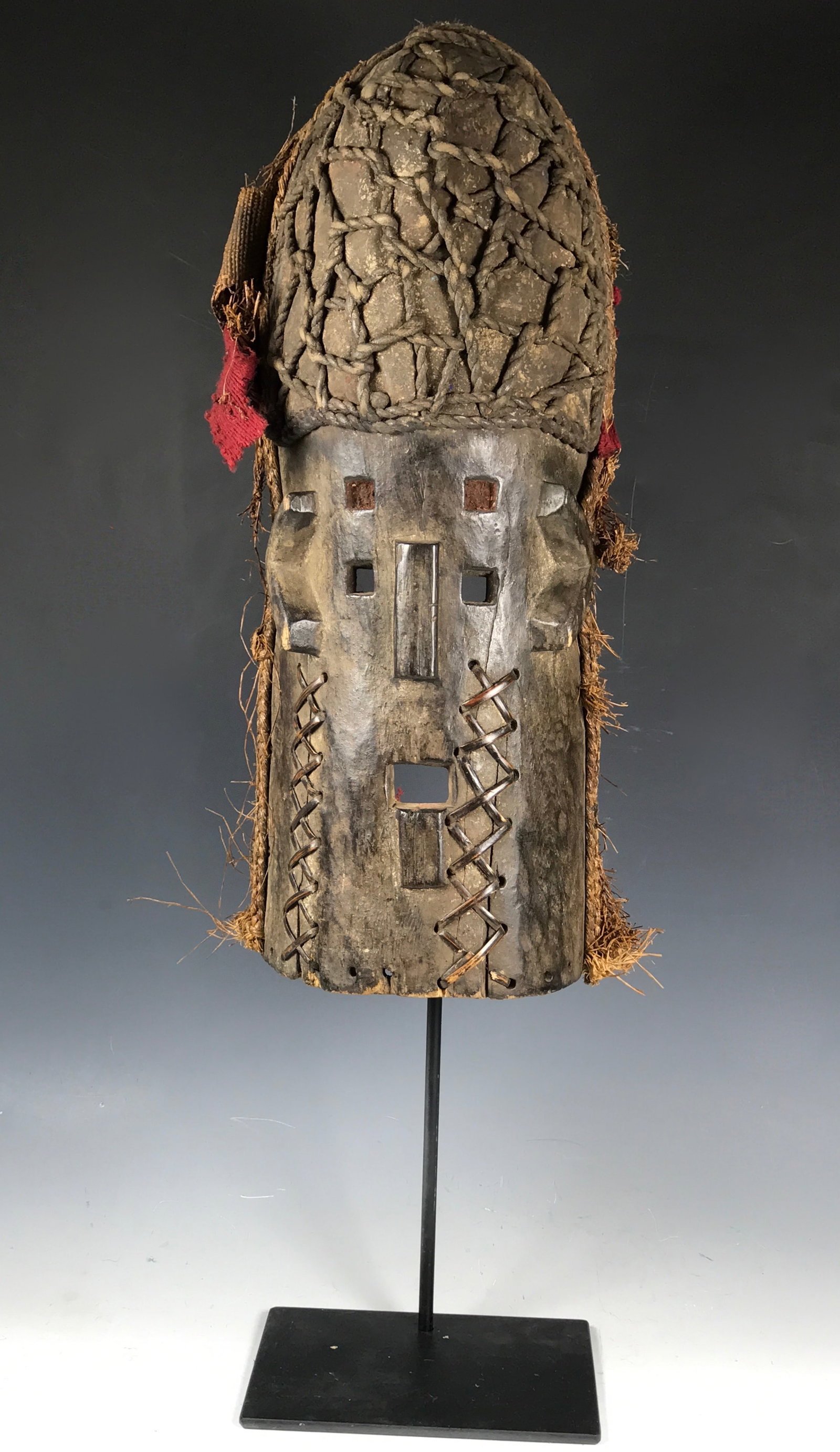 Large Carved Wood Kumu Mask with Display Stand: African Tribal Art Large Carved Wood Kumu Mask with Display Stand. The dimension is 21 inches high x 7.5 inches wide. Please be aware that some of the items are vintage, secondhand, old ages, antiques