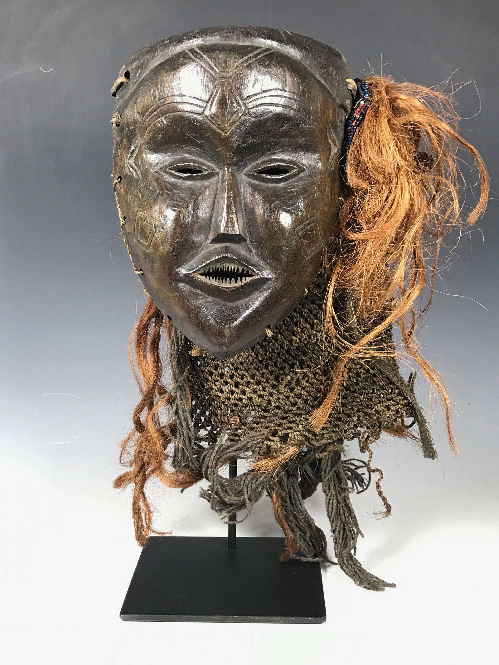 Carved Wood Chokwe Mask With Display Stand: African Tribal Art Carved Wood Chokwe Mask with Display Stand. The dimension is 18.5 inches high x 10.25 inches wide. Please be aware that some of the items are vintage, secondhand, old ages, antiques