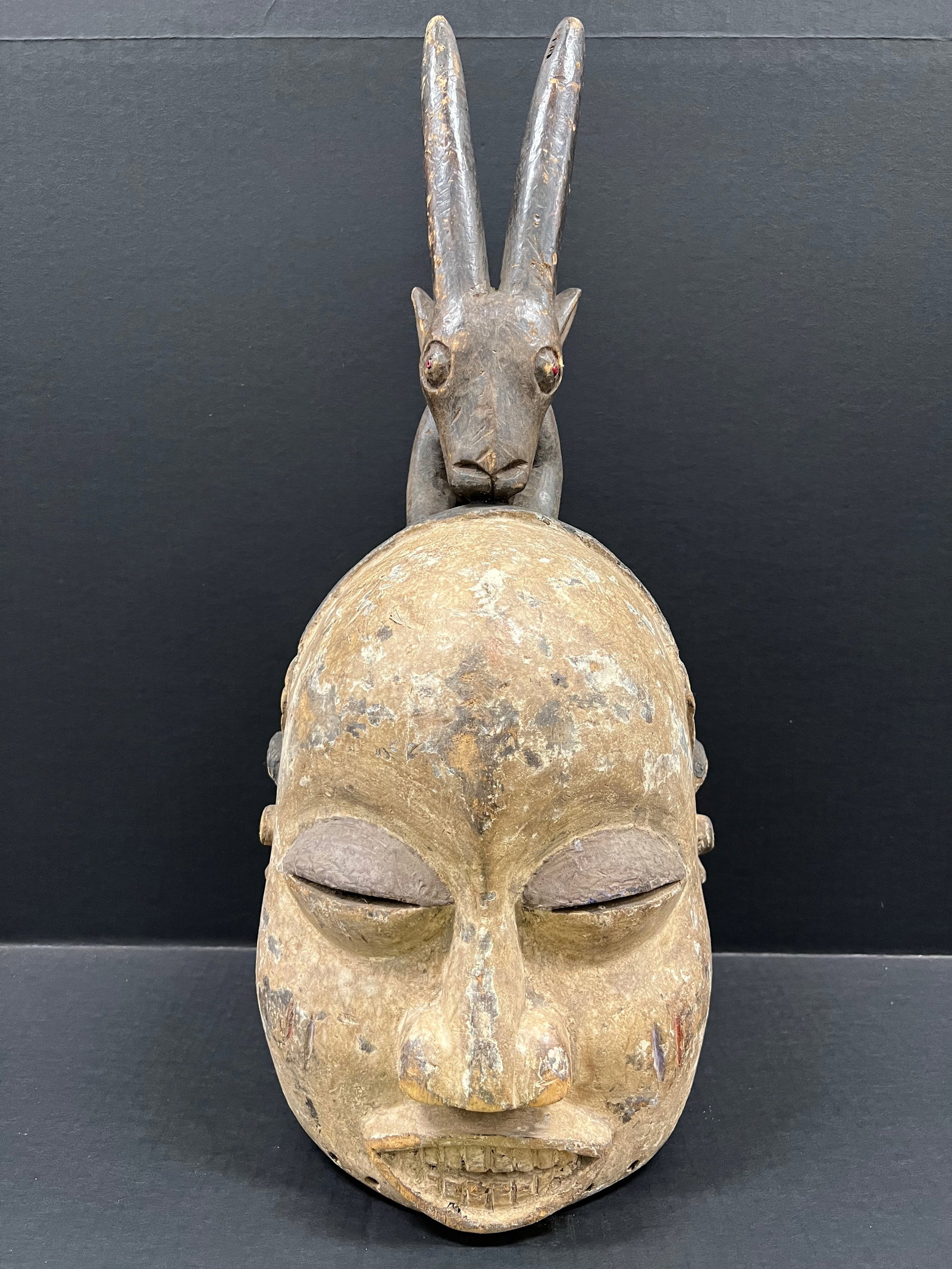 Carved Wood Suku Helmet Mask: African Tribal Art Carved Wood Suku Helmet Mask The dimension is 21 inches high x 13 inches wide. Please be aware that some of the items are vintage, secondhand, old ages, antiques and may have a defe