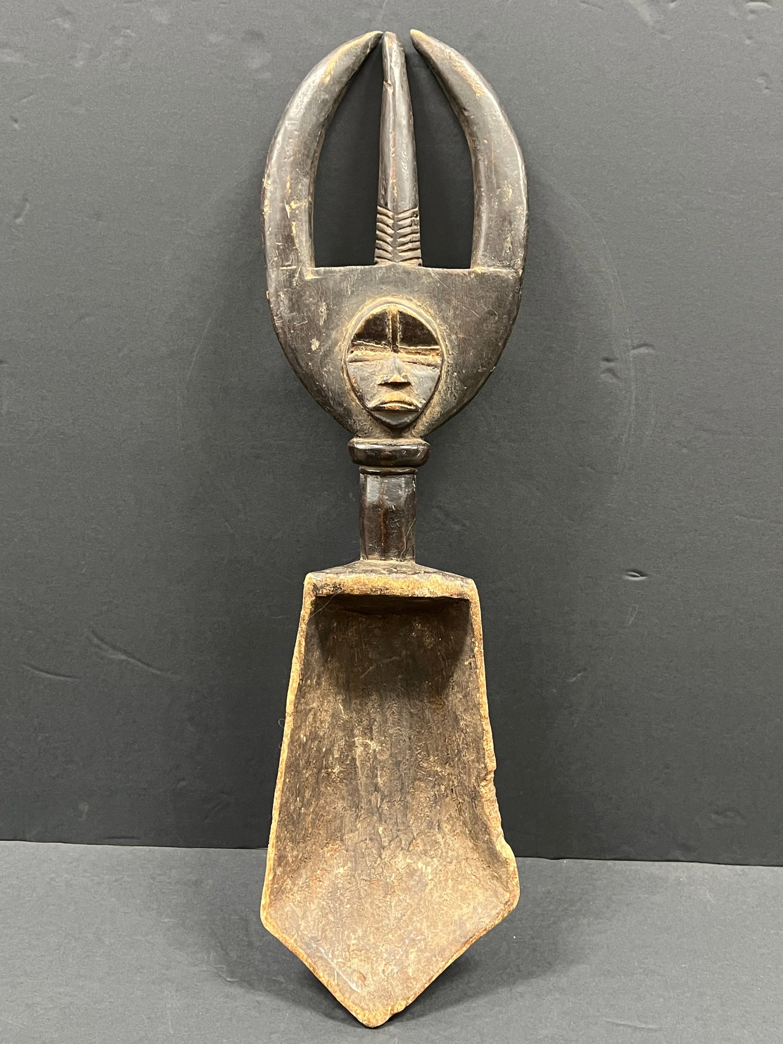 Carved Wood Dan Spoon: African Tribal Art Carved Wood Dan Spoon. The dimension is 24 inches high x 6.5 inches wide. Please be aware that some of the items are vintage, secondhand, old ages, antiques and may have a defects