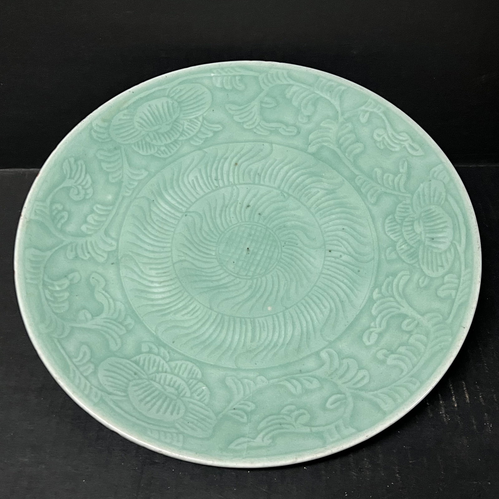 Chinese Art Celadon Porcelain Plate: Chinese Art Celadon Porcelain Plate. The dimension is 11.5 inches high x 11.5 inches wide. Please be aware that some of the items are vintage, secondhand, old ages, antiques and may have a defects or 
