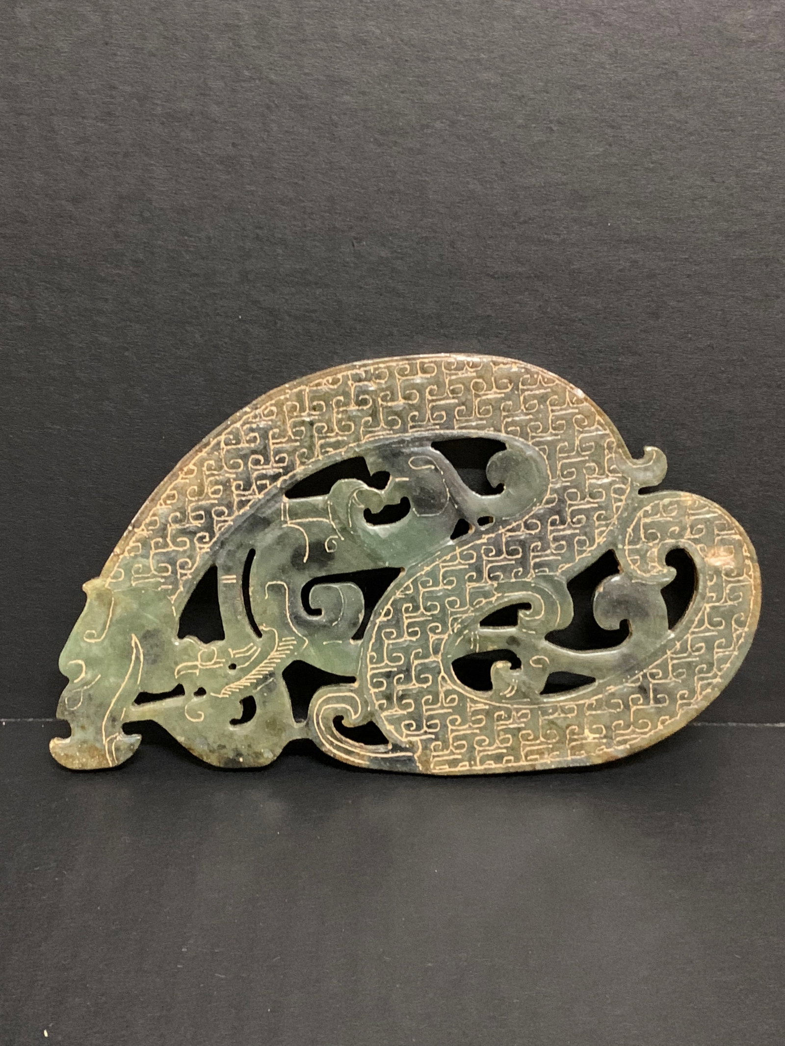 A Carved Hetian Jade Plaque with Dragon Design: Chinese Art Carved Hetian Jade Plaque with Dragon Design. The dimension is 5 inches high x 8 inches wide. Please be aware that some of the items are vintage, secondhand, old ages, antiques and may hav