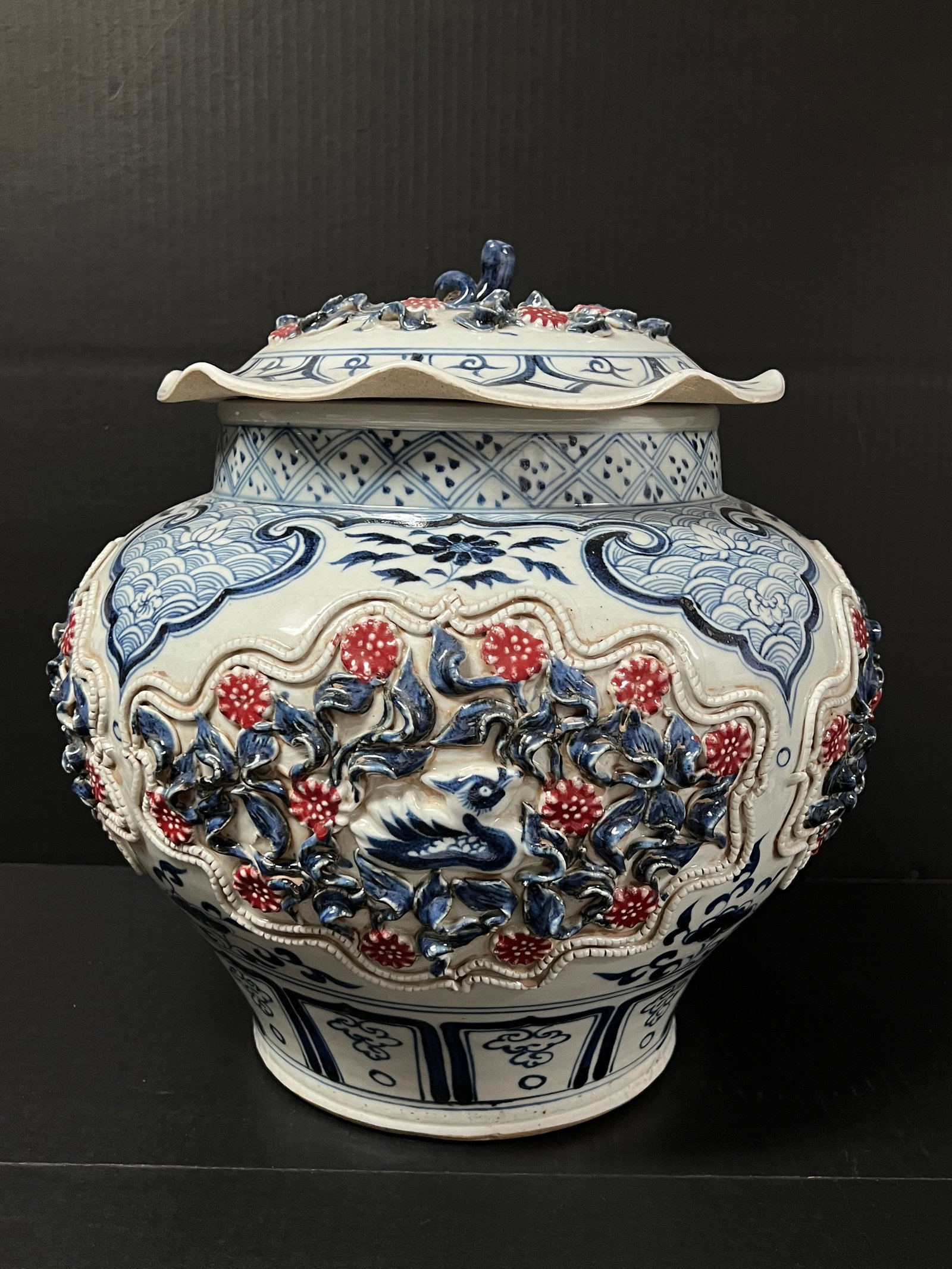 A Blue and White and Underglazed Copper Red Covered Porcelain Jar with Raised Floral Design: Chinese Art Blue and White and Underglazed copper Red Coverd Jar with Raised Floral Design. The dimension is 14 inches high x 13.5 inches wide. Please be aware that some of the items are vintage, seco