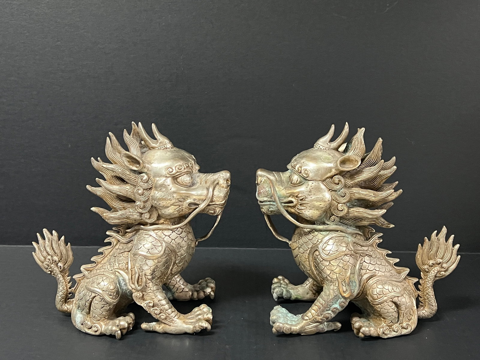 Pair of Silver Gilt Bronze Feng Shui Qilin Dog Sculpture: Chinese Art Silver Gilt Bronze Feng Shui Qilin Dog Sculpture Sculpture. The dimension is 9 inches high x 8 inches wide. Please be aware that some of the items are vintage, secondhand, old ages, antiqu