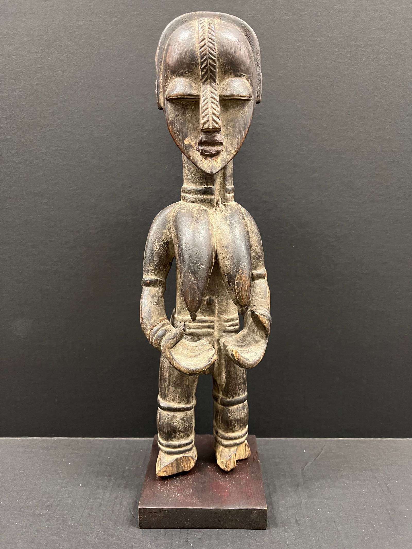 Carved Wood Bassa Statue: African Tribal Art Carved Wood Bassa Statue with Display Stand . The dimension is 20.5 inches high x 6 inches wide. Please be aware that some of the items are vintage, secondhand, old ages, antiques