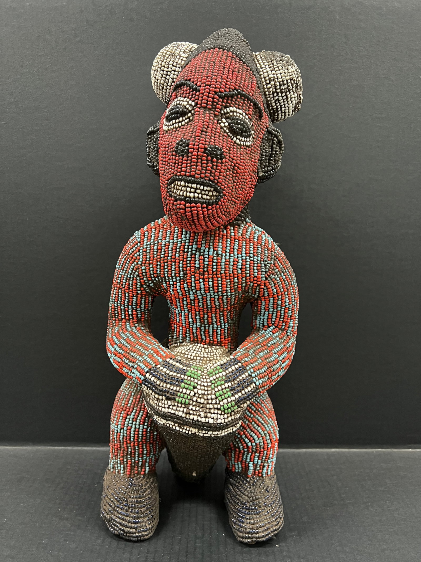Carved Wood Bamileke Beaded Statue: African Tribal Art Carved Wood Bamileke Beaded Statue. The dimension is 21inches high x 8.5 inches wide. Please be aware that some of the items are vintage, secondhand, old ages, antiques and may have