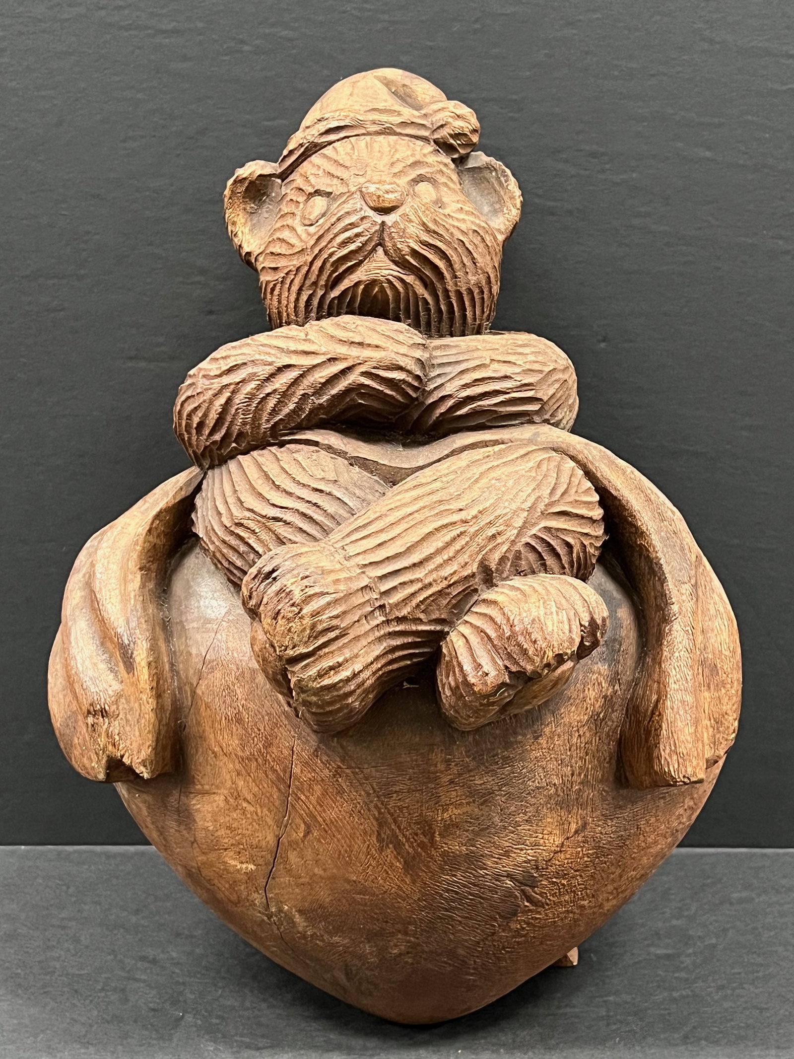 Hand Carved Wooden Teddy Bear Sitting in Heart Sculpture: Folk Art Hand Carved Wood Teddy Bear Sitting in Heart Sculpture. The dimension is 15 inches high x 9 inches wide. Please be aware that some of the items are vintage, secondhand, old ages, antiques and