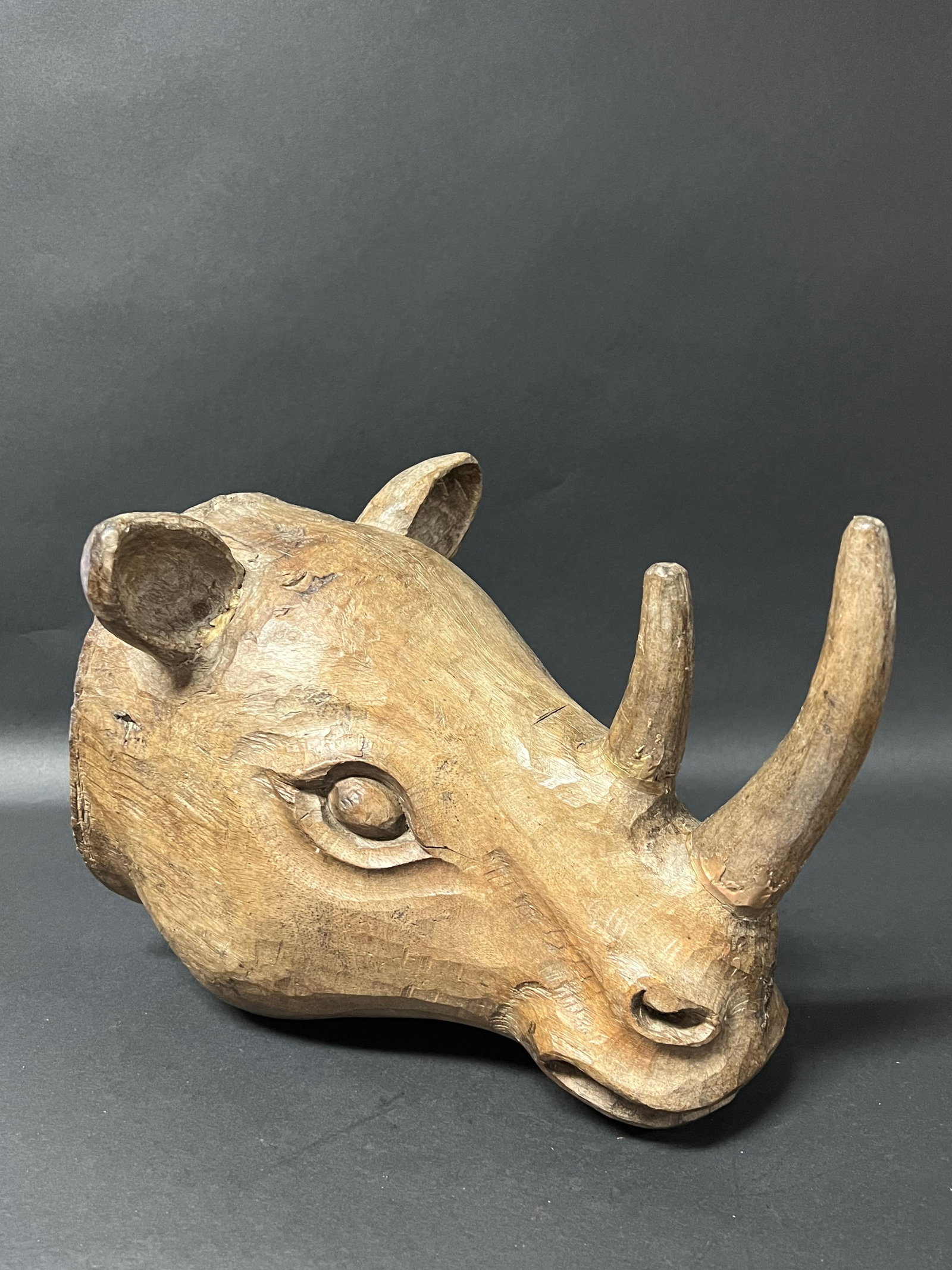 Hand Carved Wooden Rhinoceros Sculpture: Folk Art Hand Carved Wooden Rhinoceros Sculpture. The dimension is 9 inches high x 11 inches wide. Please be aware that some of the items are vintage, secondhand, old ages, antiques and may have a def