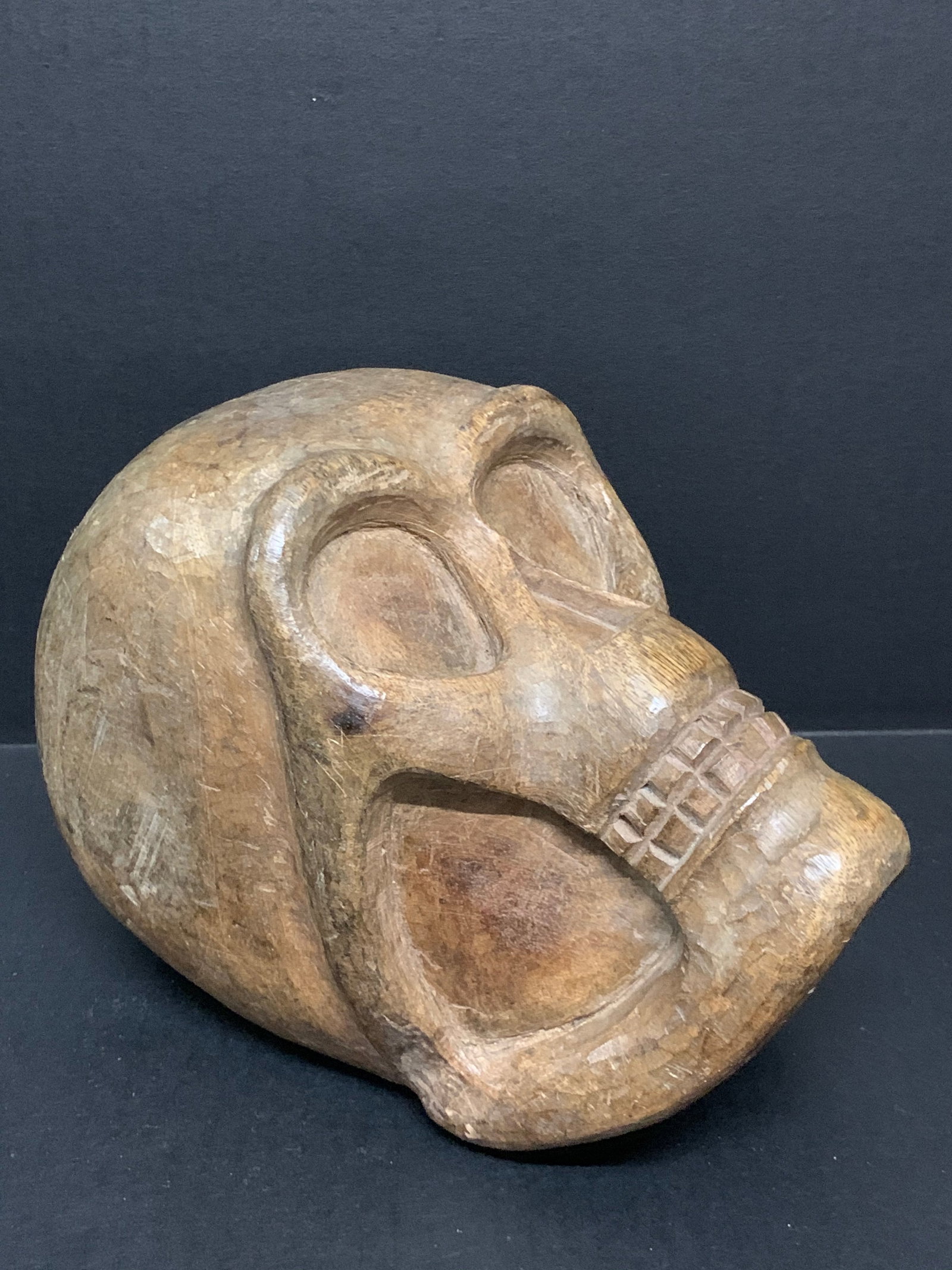 Hand Carved Wooden Large Skull Sculpture: Folk Art Hand Carved Wooden Large Skull Sculpture. The dimension is 6.75 inches high x 5 inches wide. Please be aware that some of the items are vintage, secondhand, old ages, antiques and may have a 